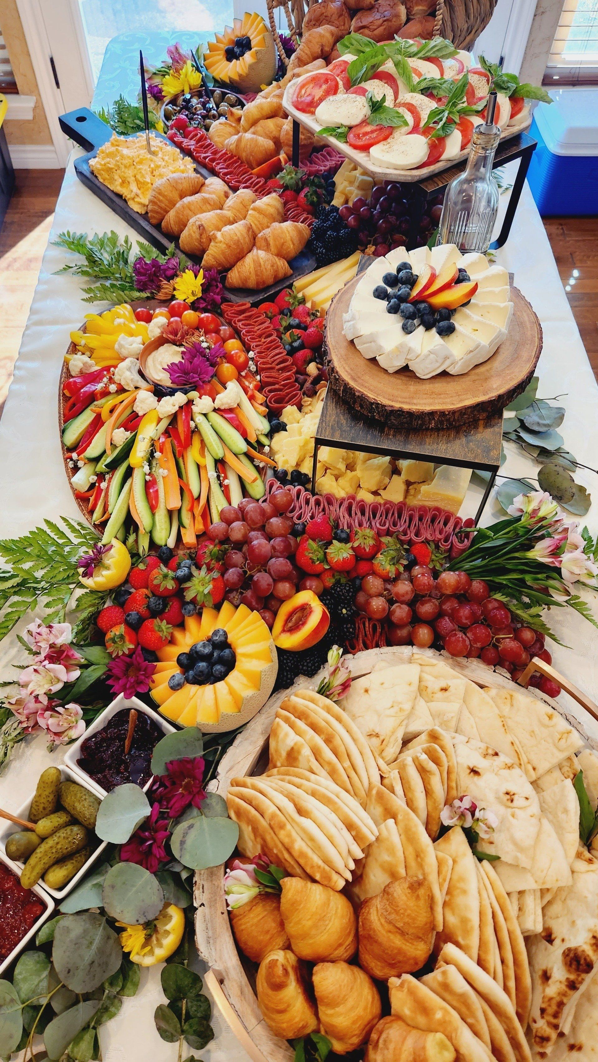A large buffet table filled with lots of food and vegetables.