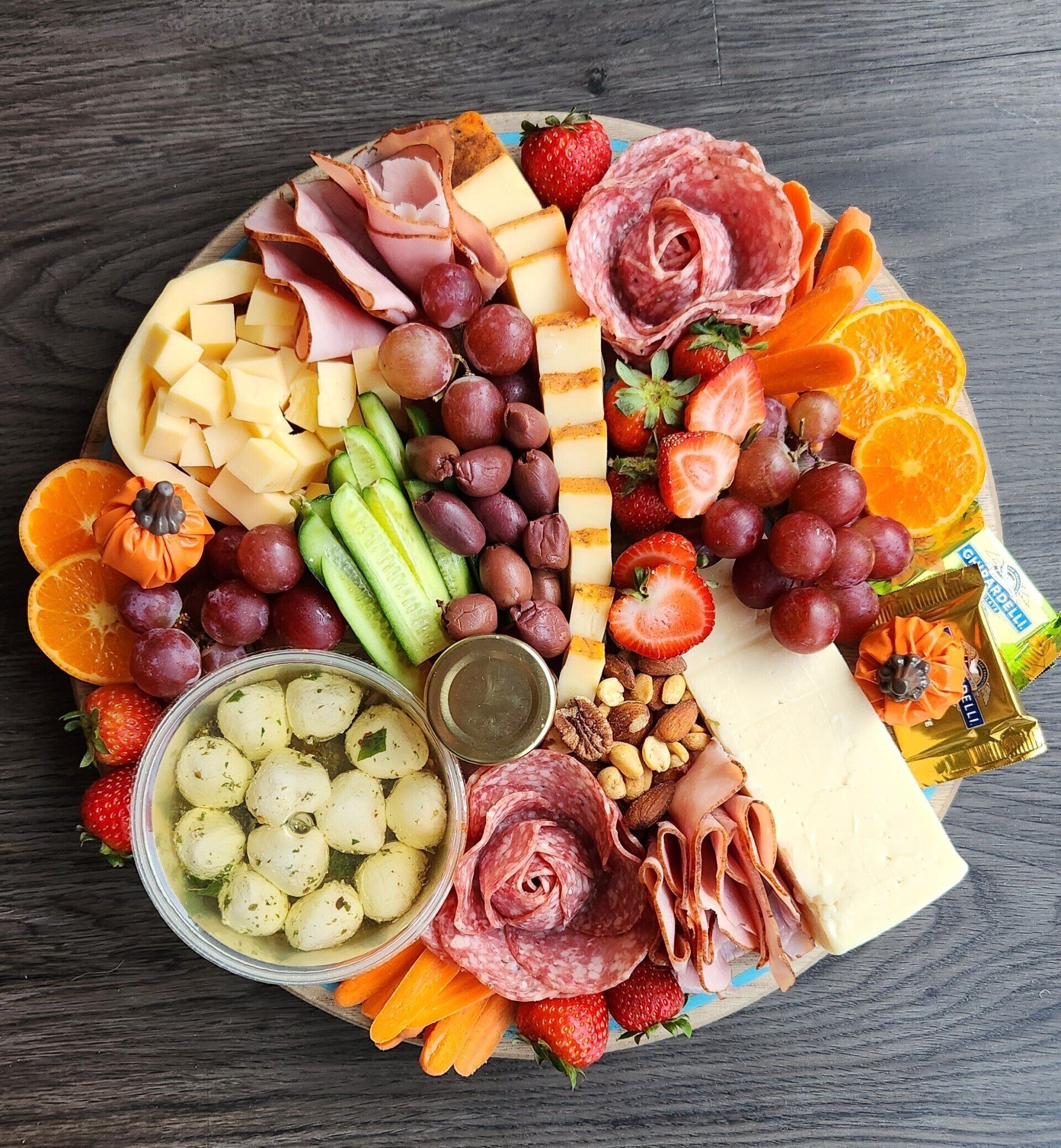 A wooden cutting board filled with a variety of fruits and vegetables.