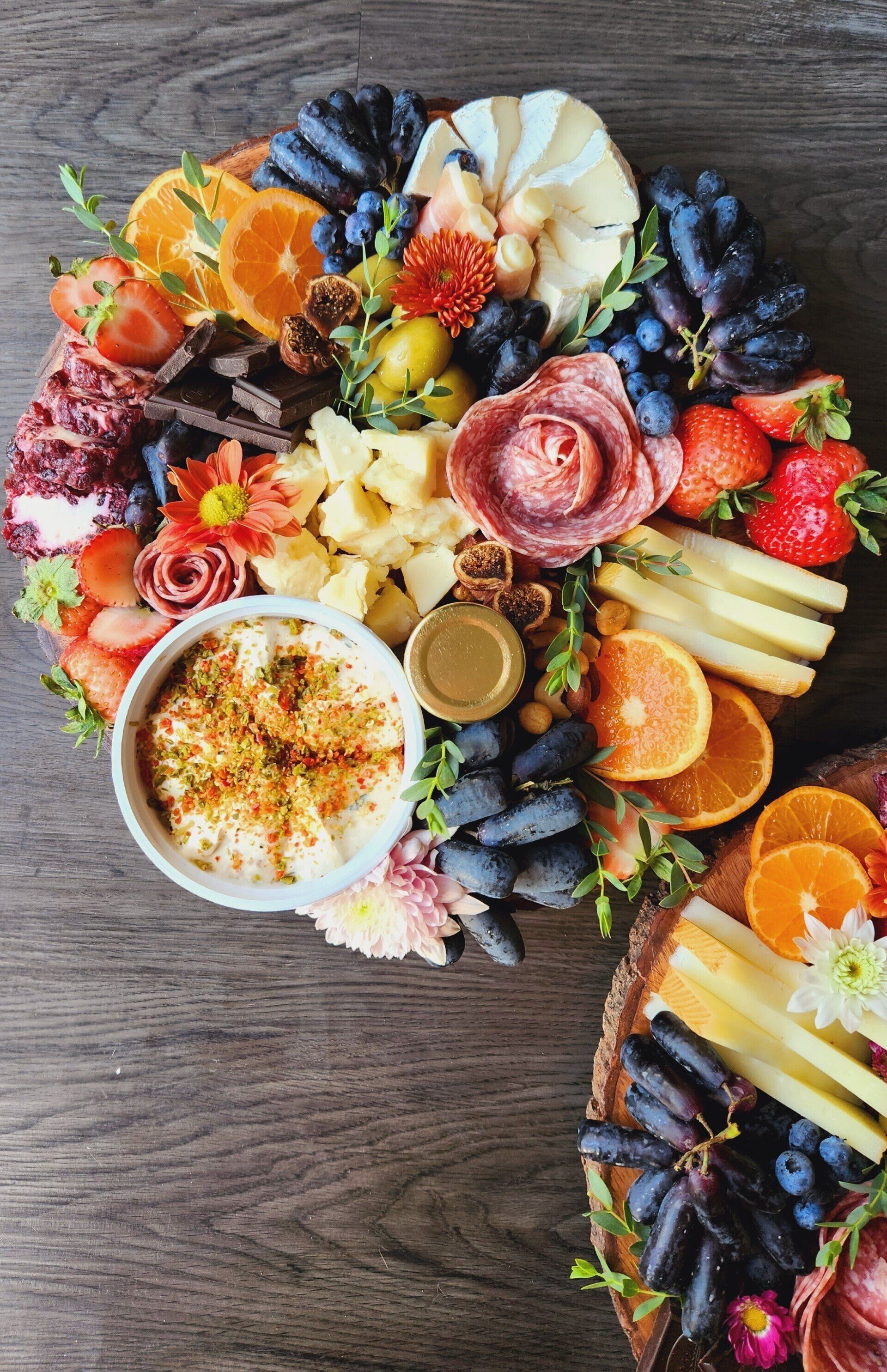 A wooden table topped with a variety of fruits and cheeses.