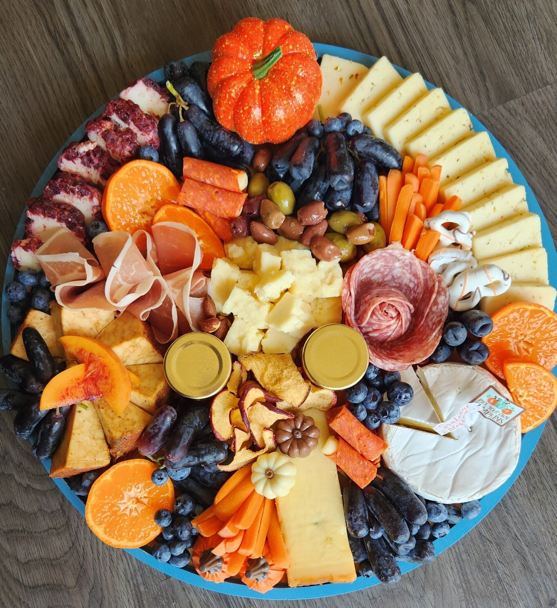 A blue plate topped with a variety of fruits and vegetables.