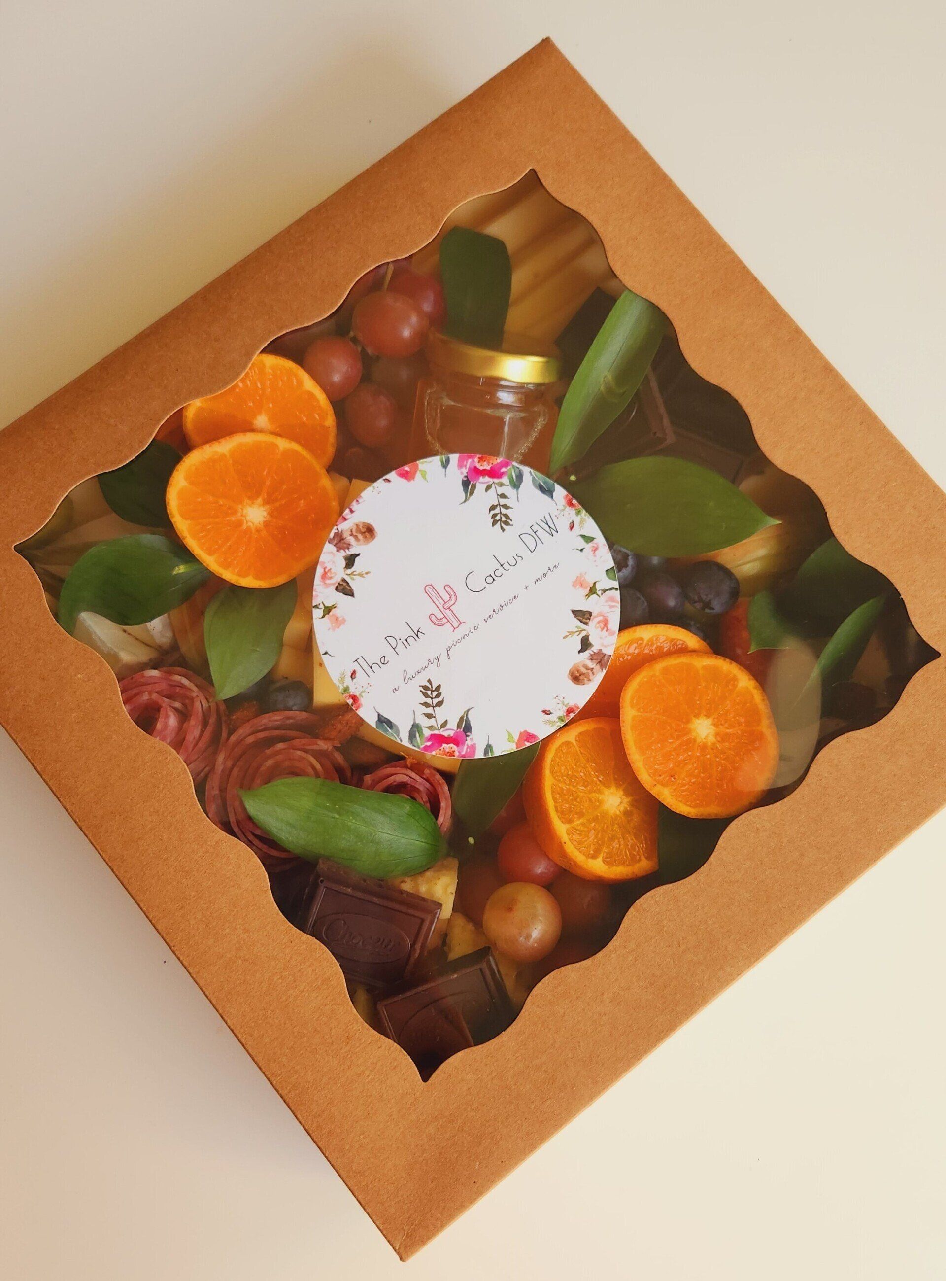 A box of fruits and vegetables with a label that says ' handmade ' on it