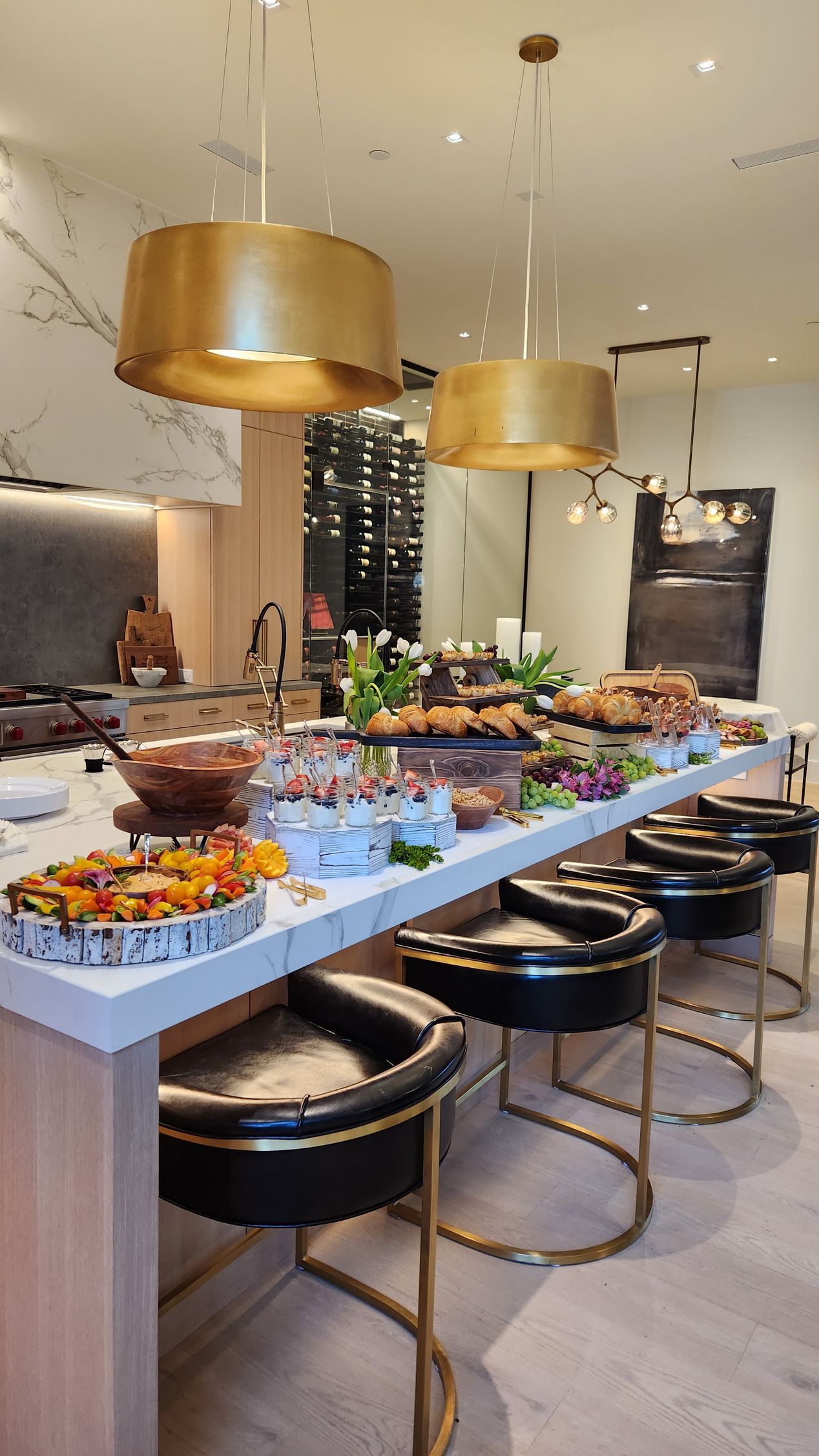 A long table with a lot of food on it in a kitchen.