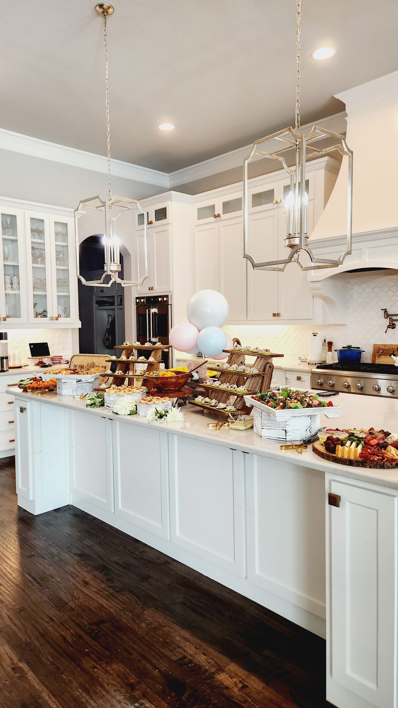 A kitchen with a long counter filled with food.