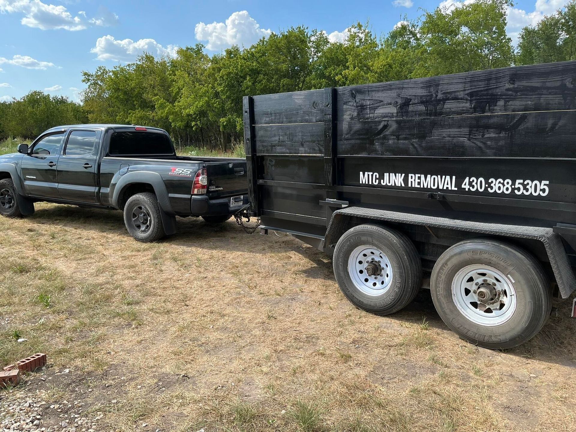 Black truck towing a black trailer with 