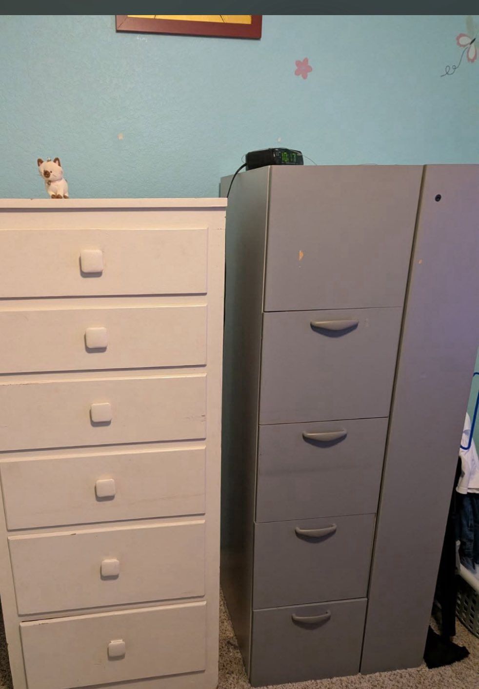 White dresser and gray filing cabinet side-by-side against a blue wall.