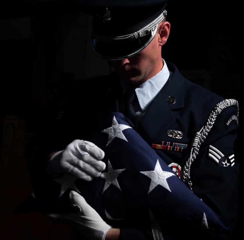 A man is standing in front of an open bible in a church.