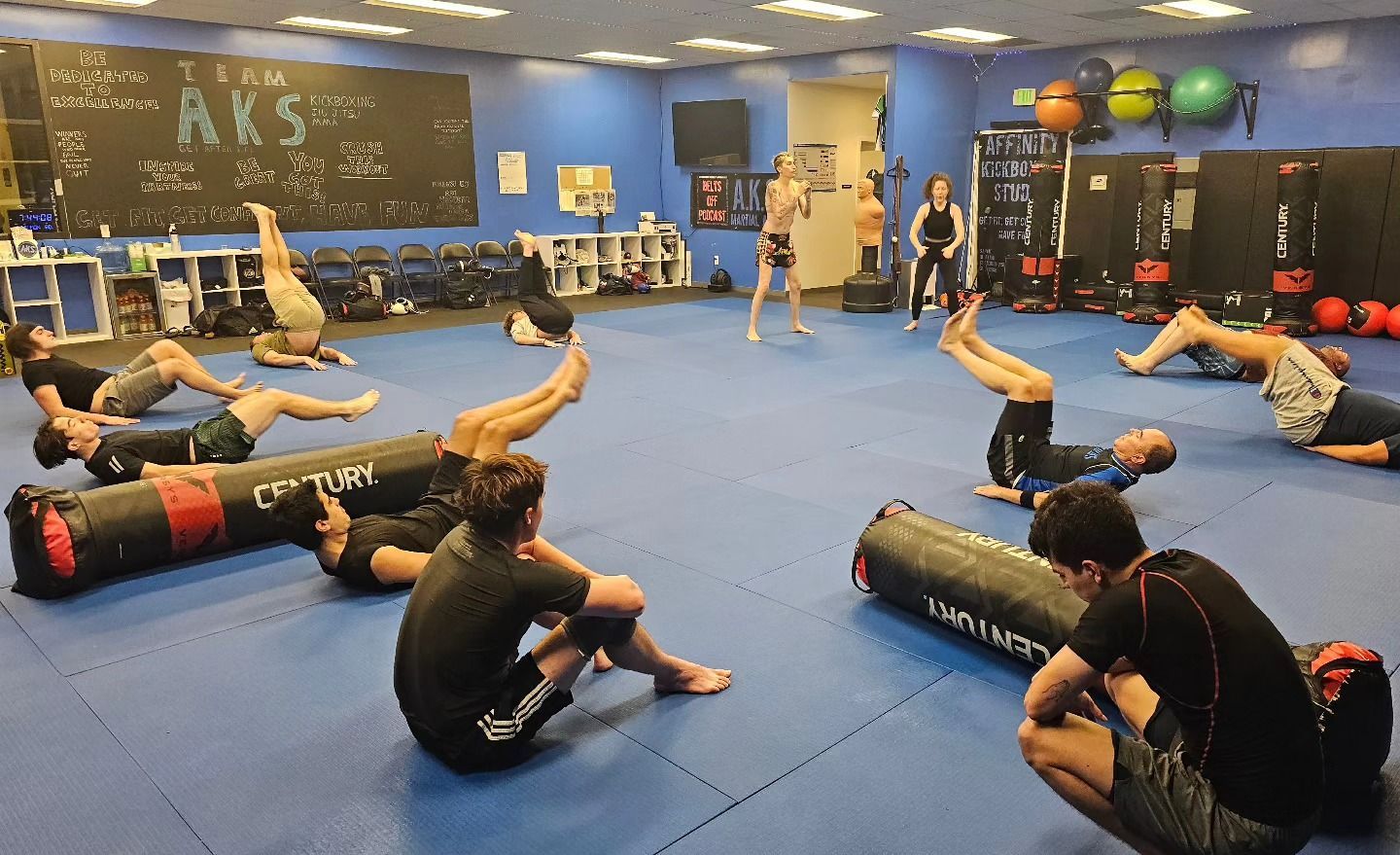 A group of people are doing exercises in a gym.