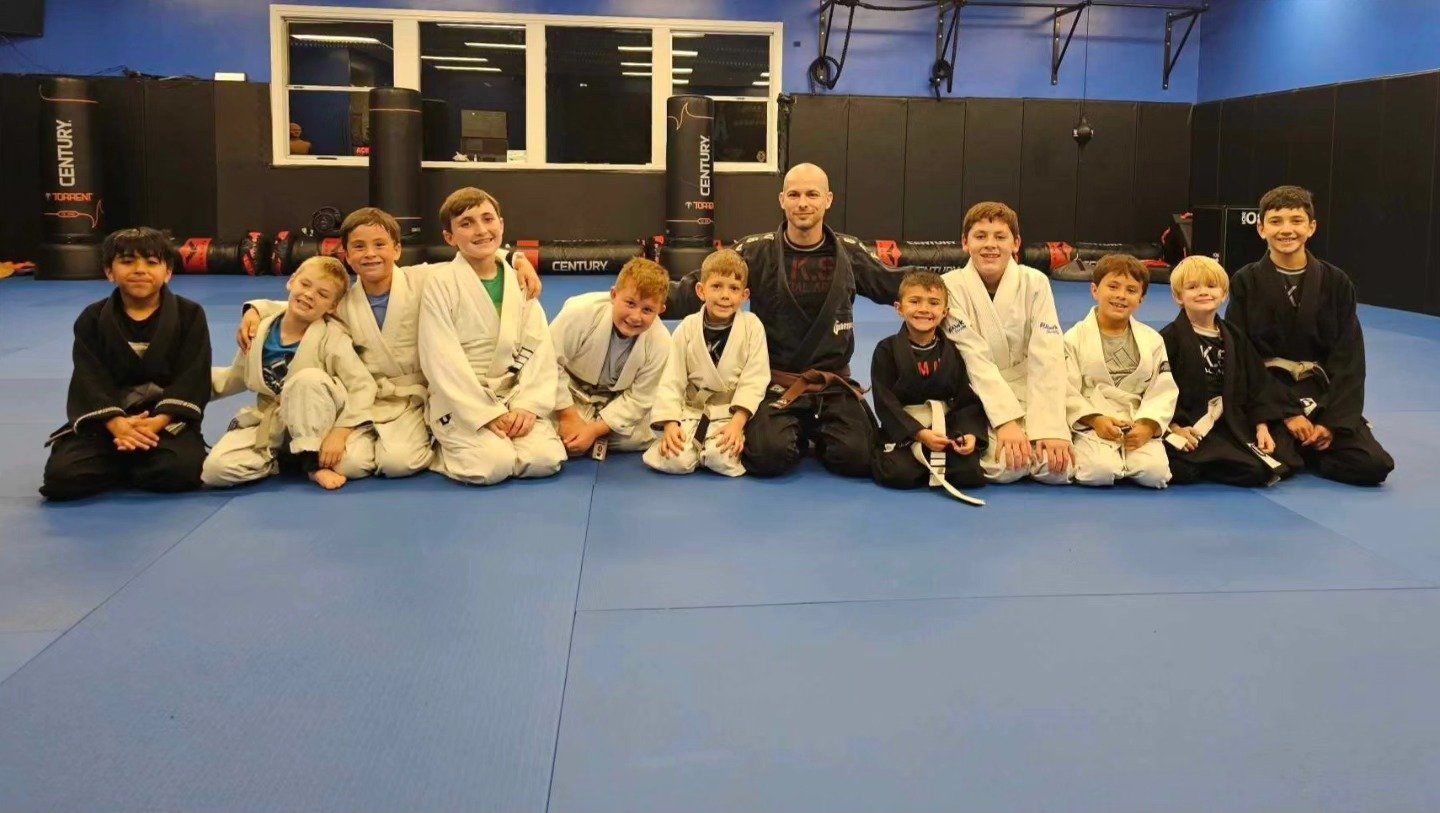 A group of young boys are posing for a picture in a gym.