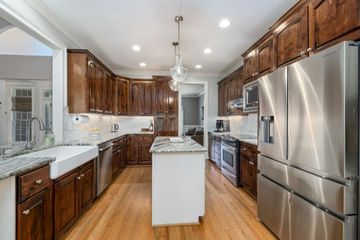 A kitchen with stainless steel appliances and wooden cabinets