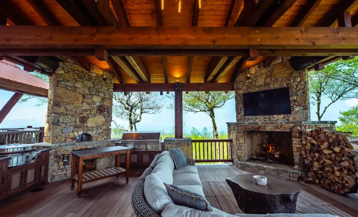 A living room with a couch , fireplace and television.