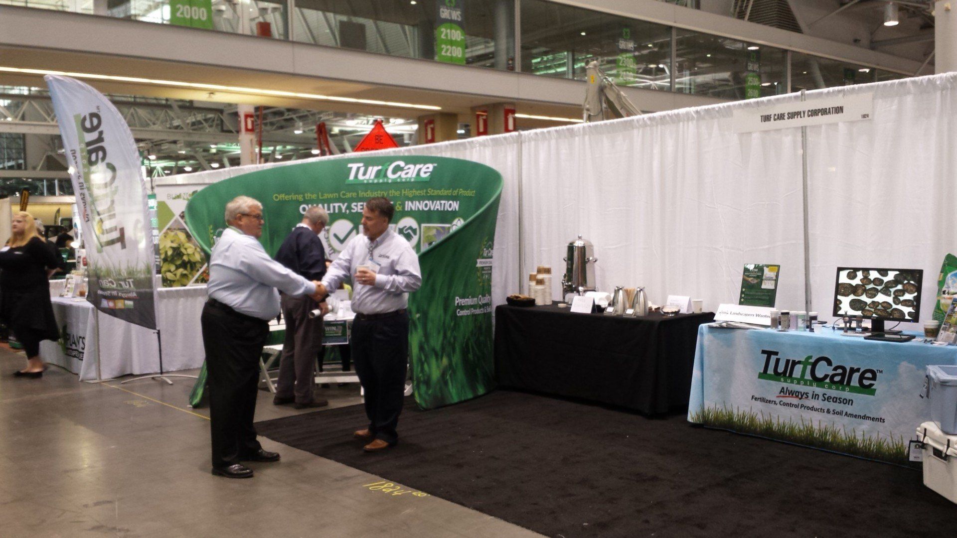 new england grows mark mangan shaking hands at the turfcare booth