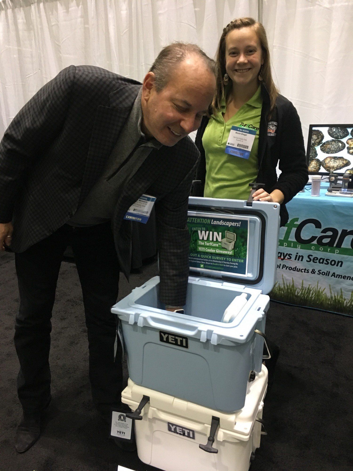 new england grows william milowitz reaching into yeti cooler for prize giveaway with nicole