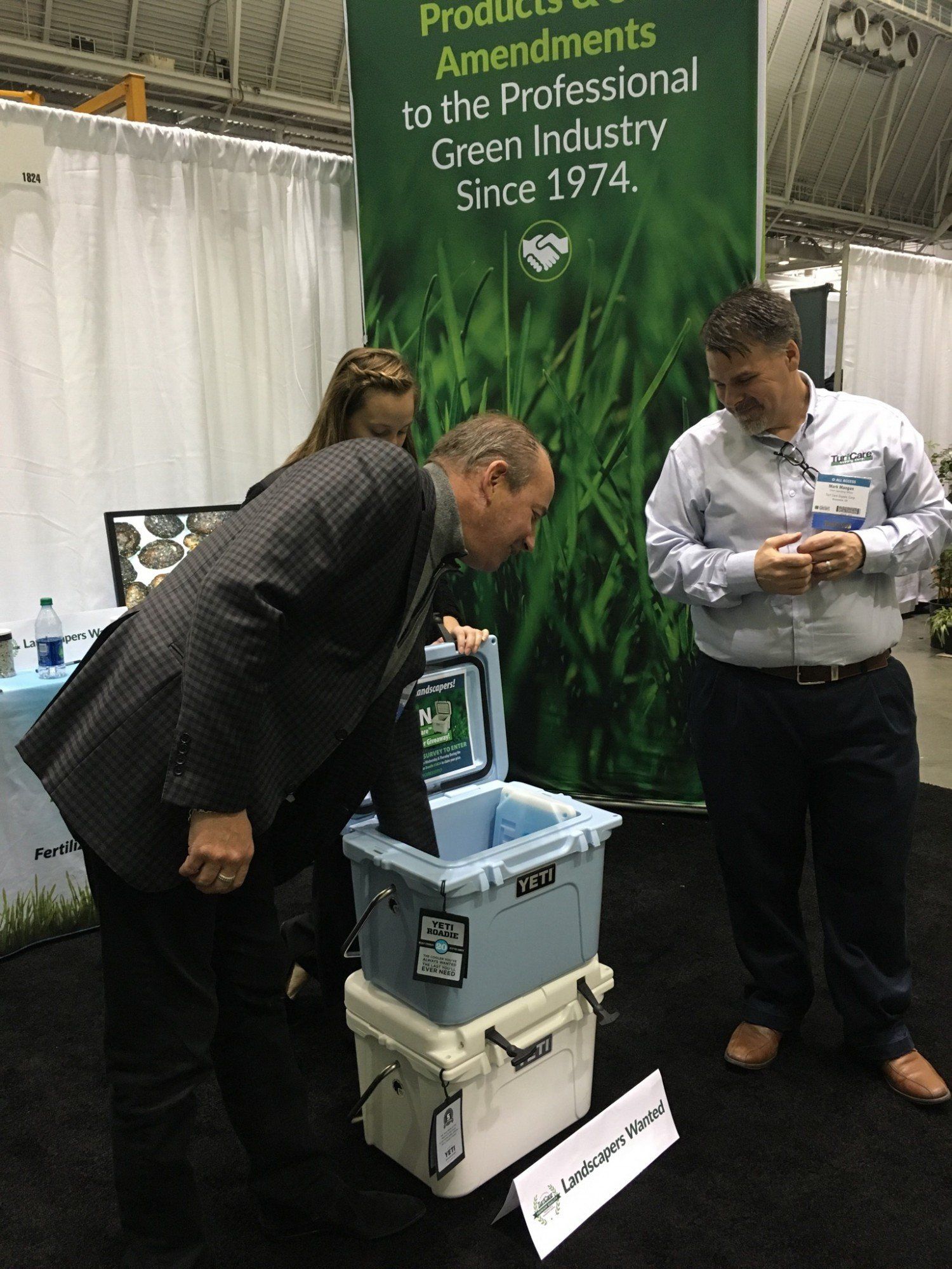 new england grows william milowitz reaching in yeti cooler for prize give away while mark mangan looks on
