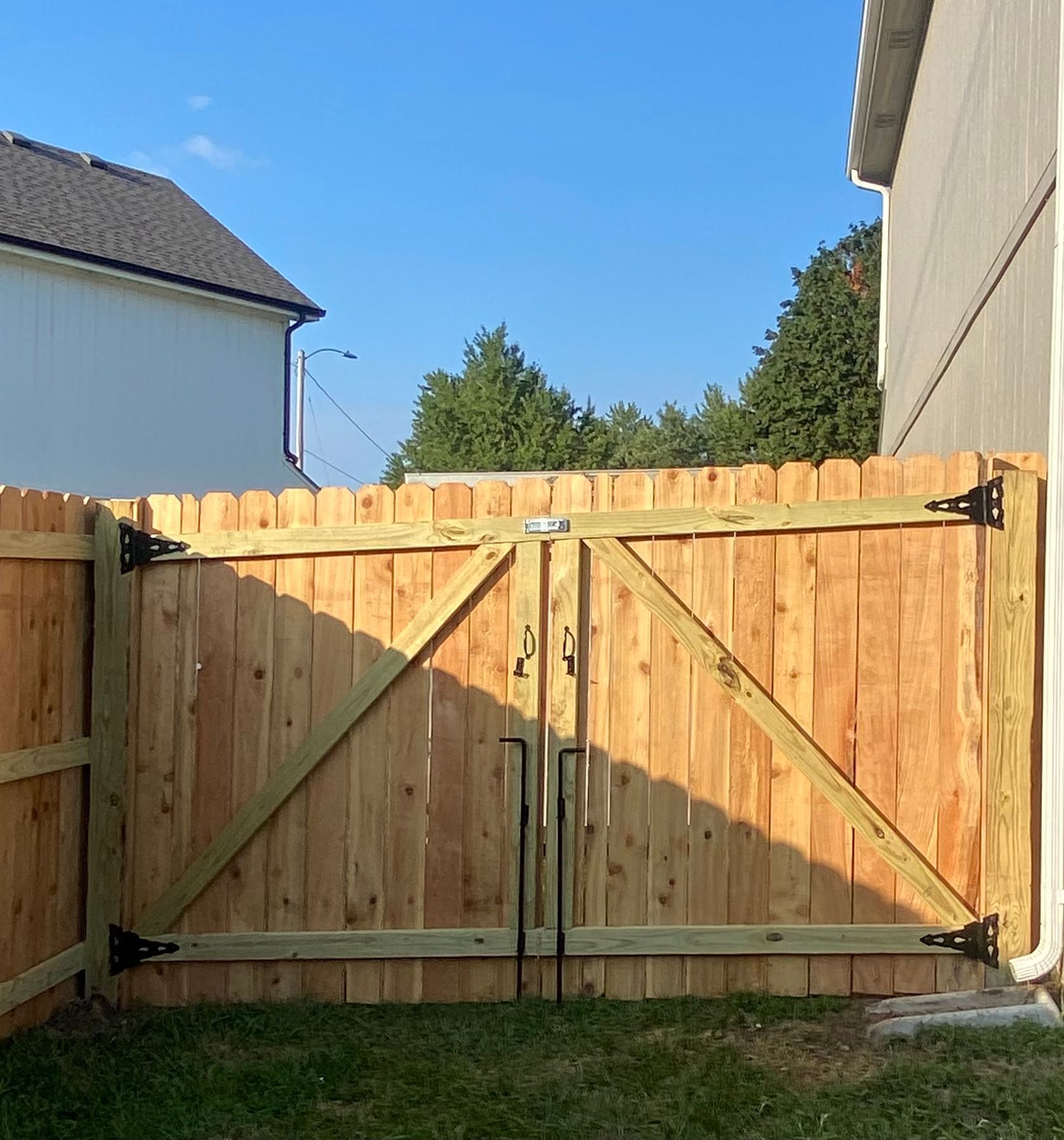 A wooden fence with a gate in the backyard