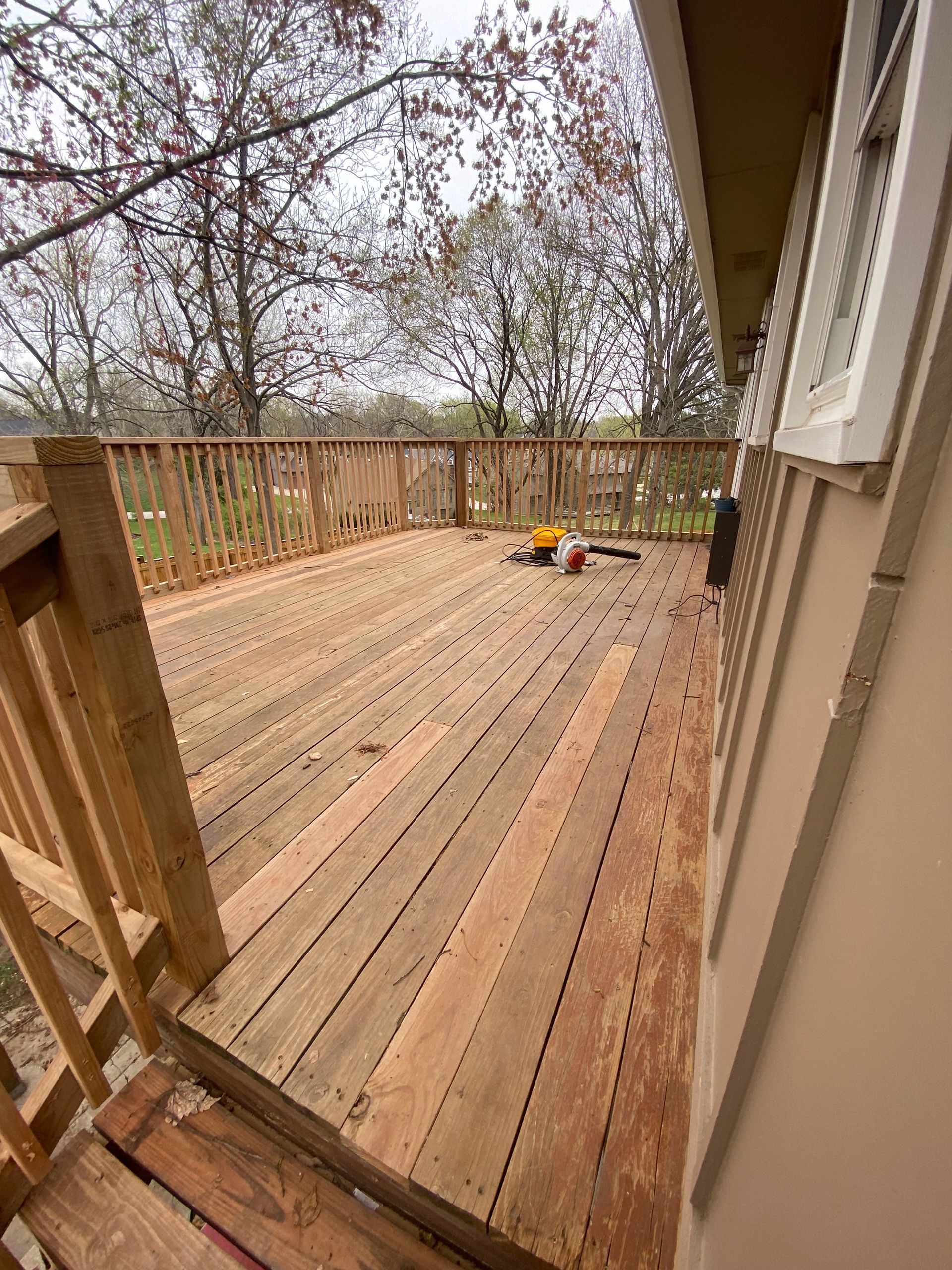 A wooden deck is being built on the side of a house.