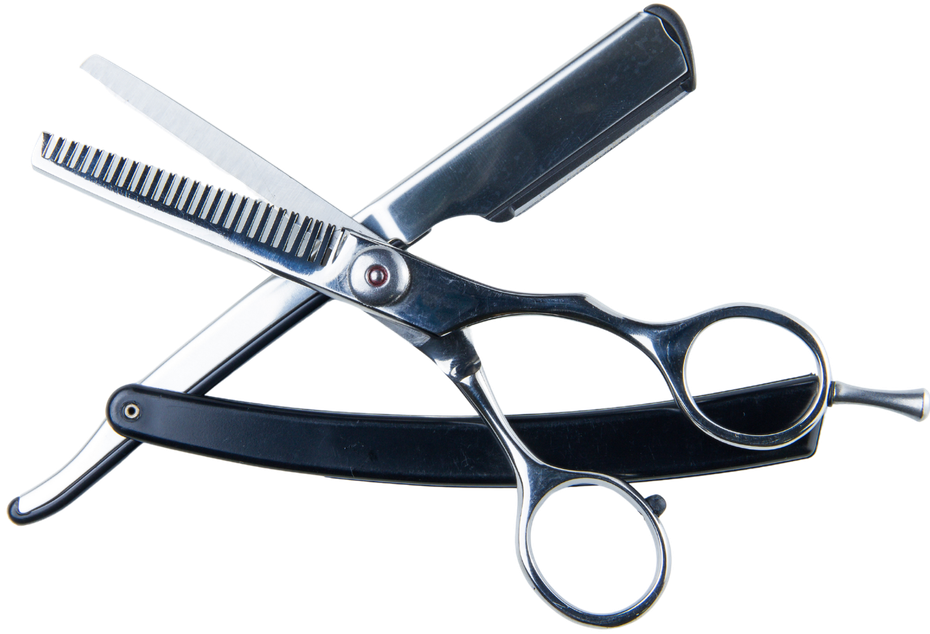 A pair of scissors laying on top of a razor