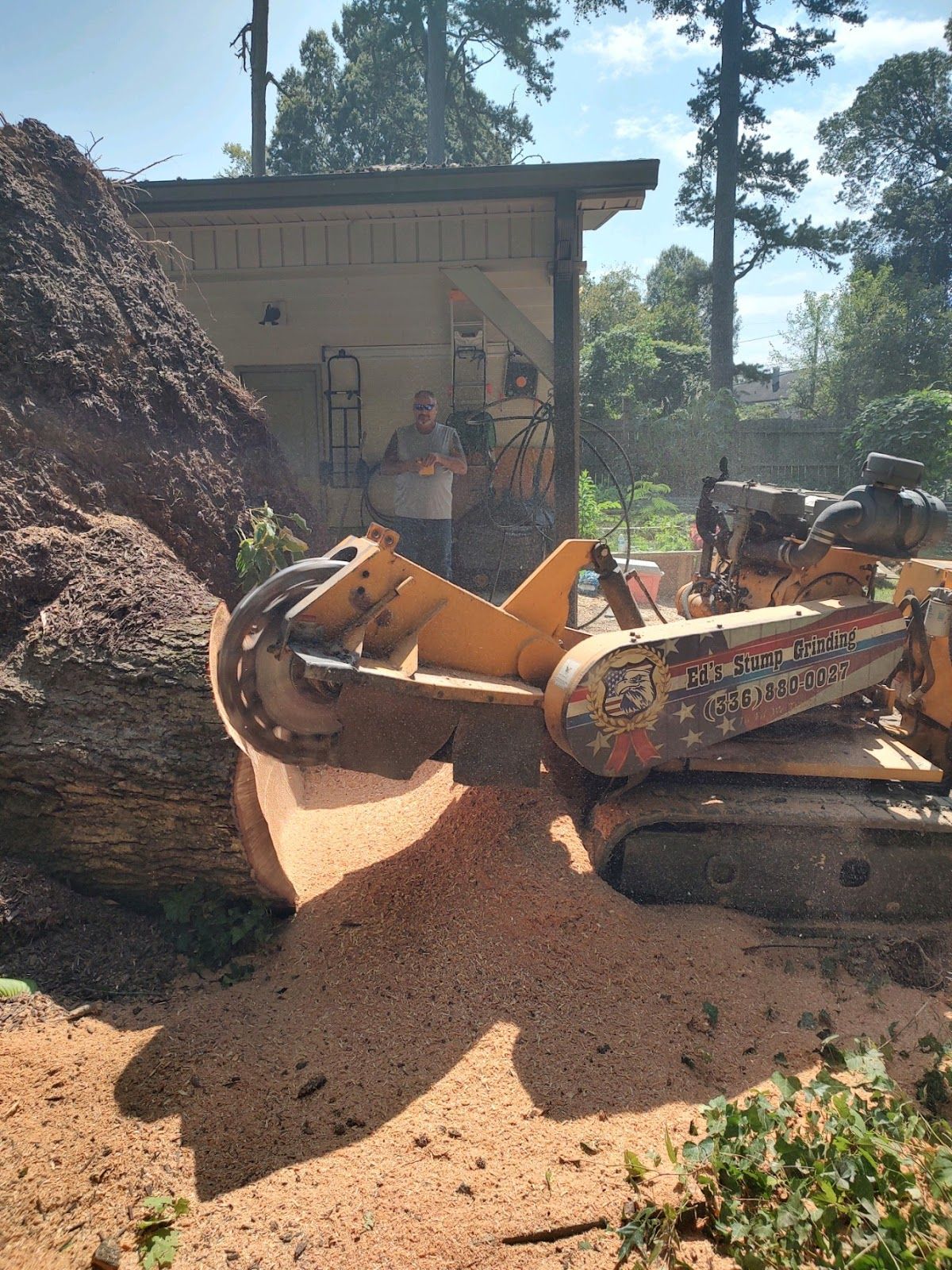 A stump grinder is cutting a large tree stump.
