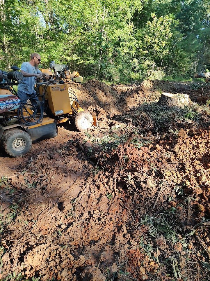 A man is driving a tractor through a muddy field.