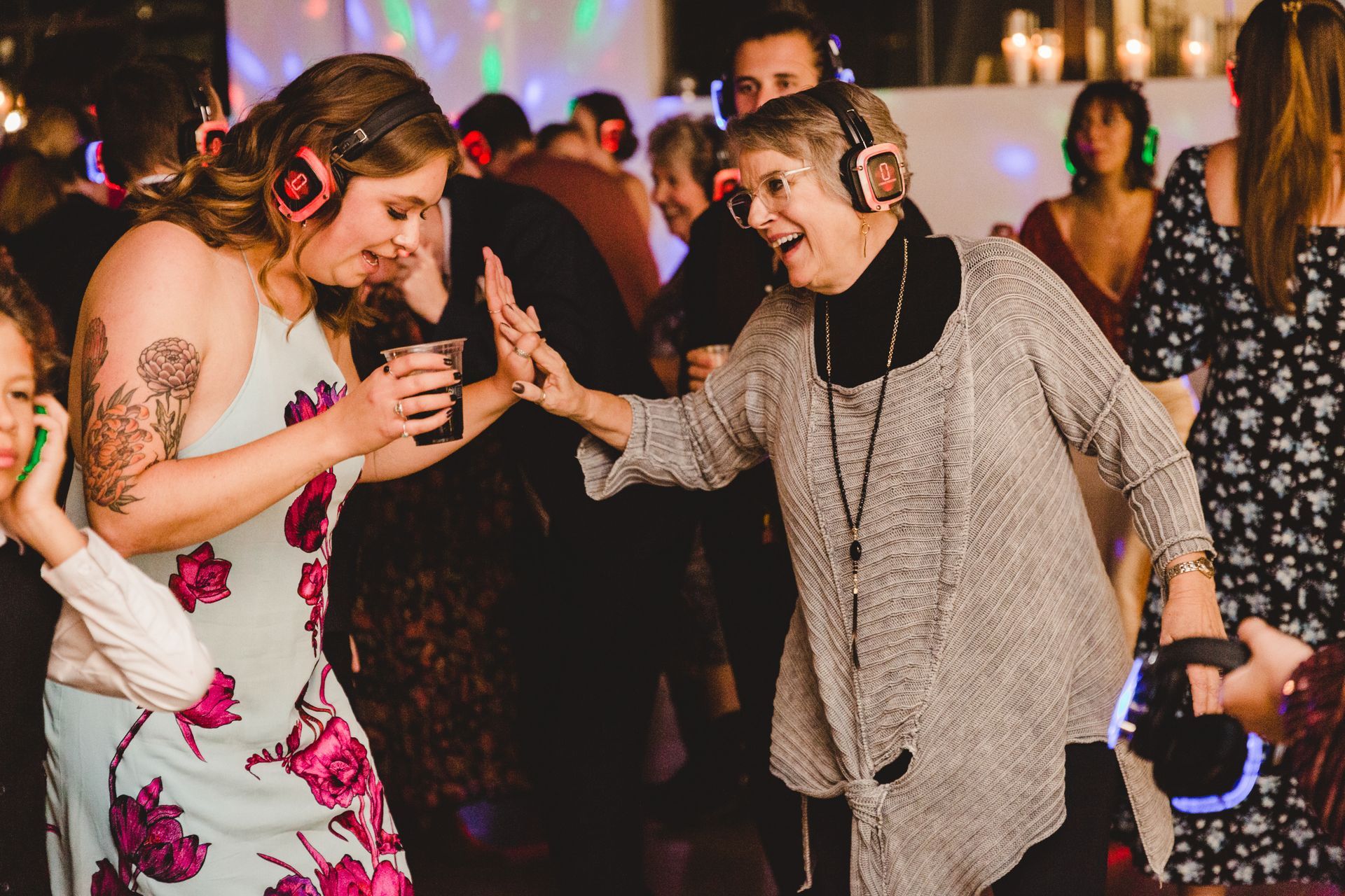 middle age and elderly join hands while listening to silent disco