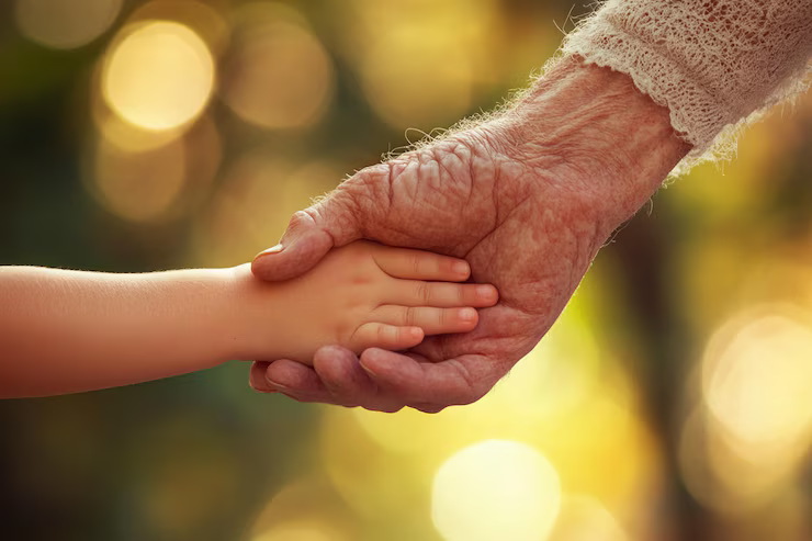 kid and elderly holding hands