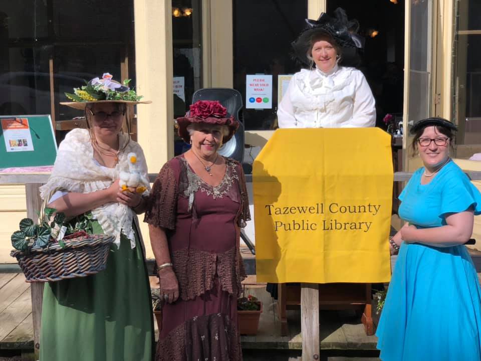 A group of women are standing in front of a tazewell county public library.