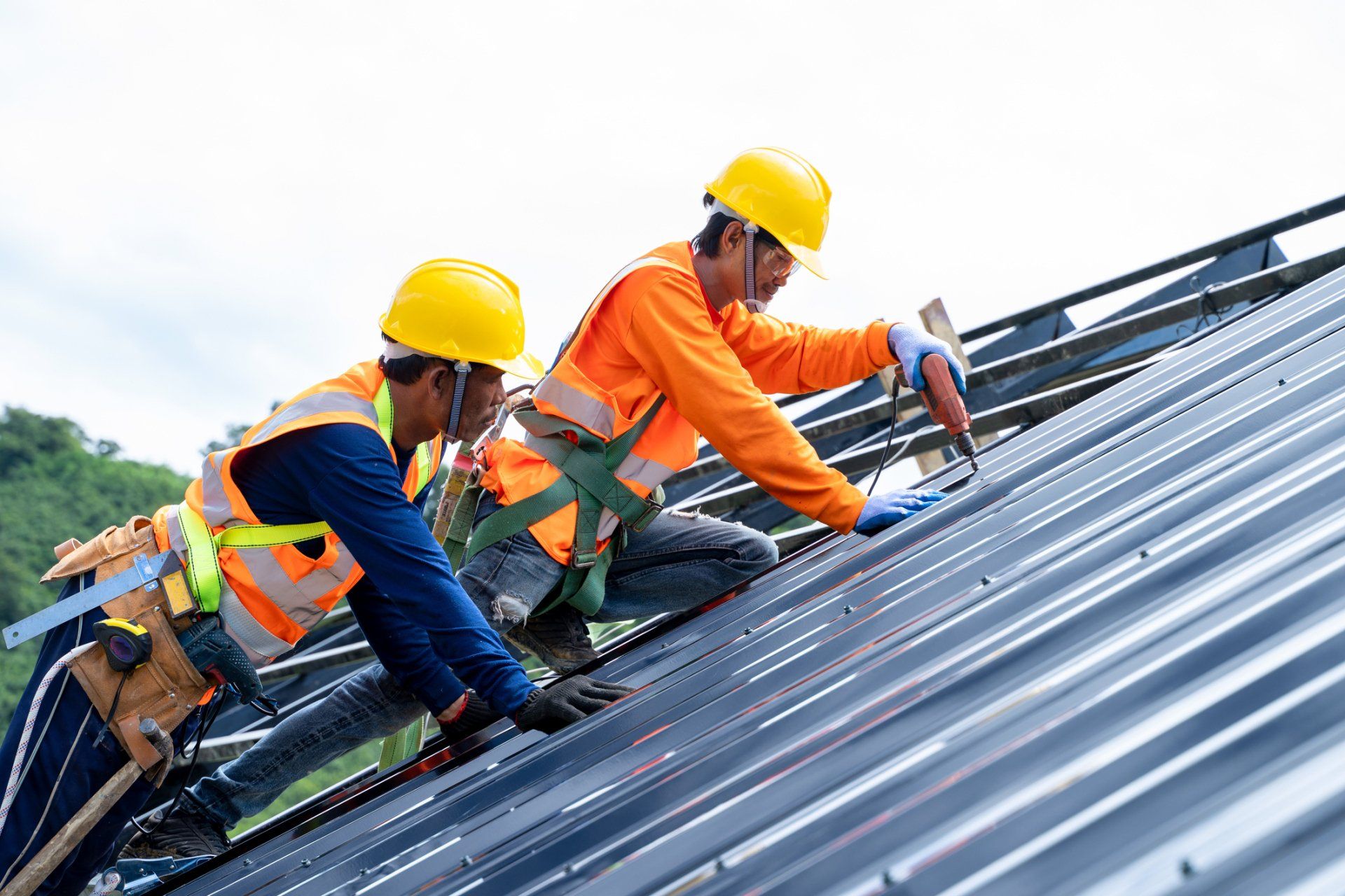 Roof Repairs — Man with red cap fixing roof in Port Orange, FL