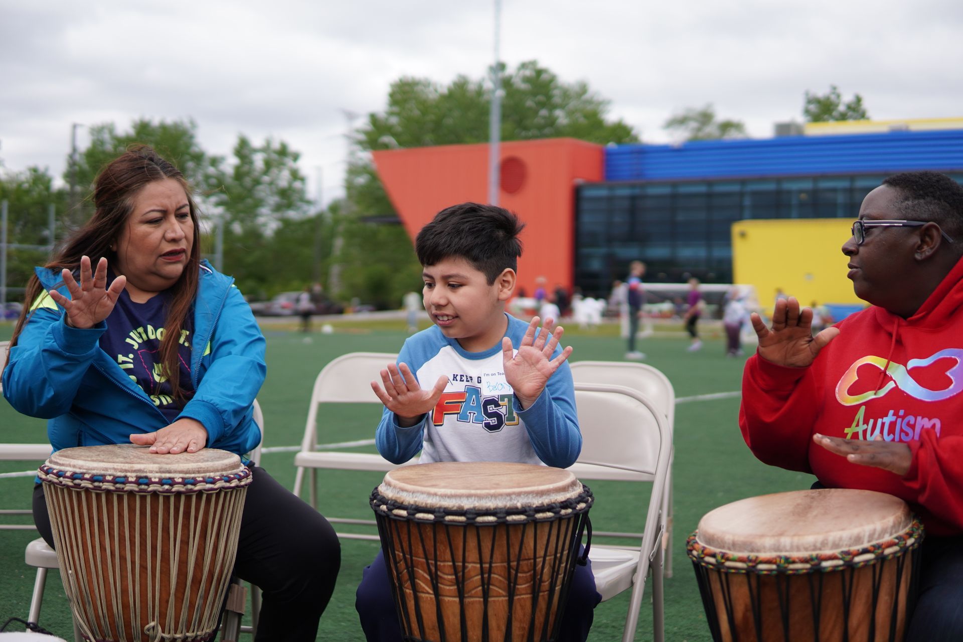 A young athlete plays a drum