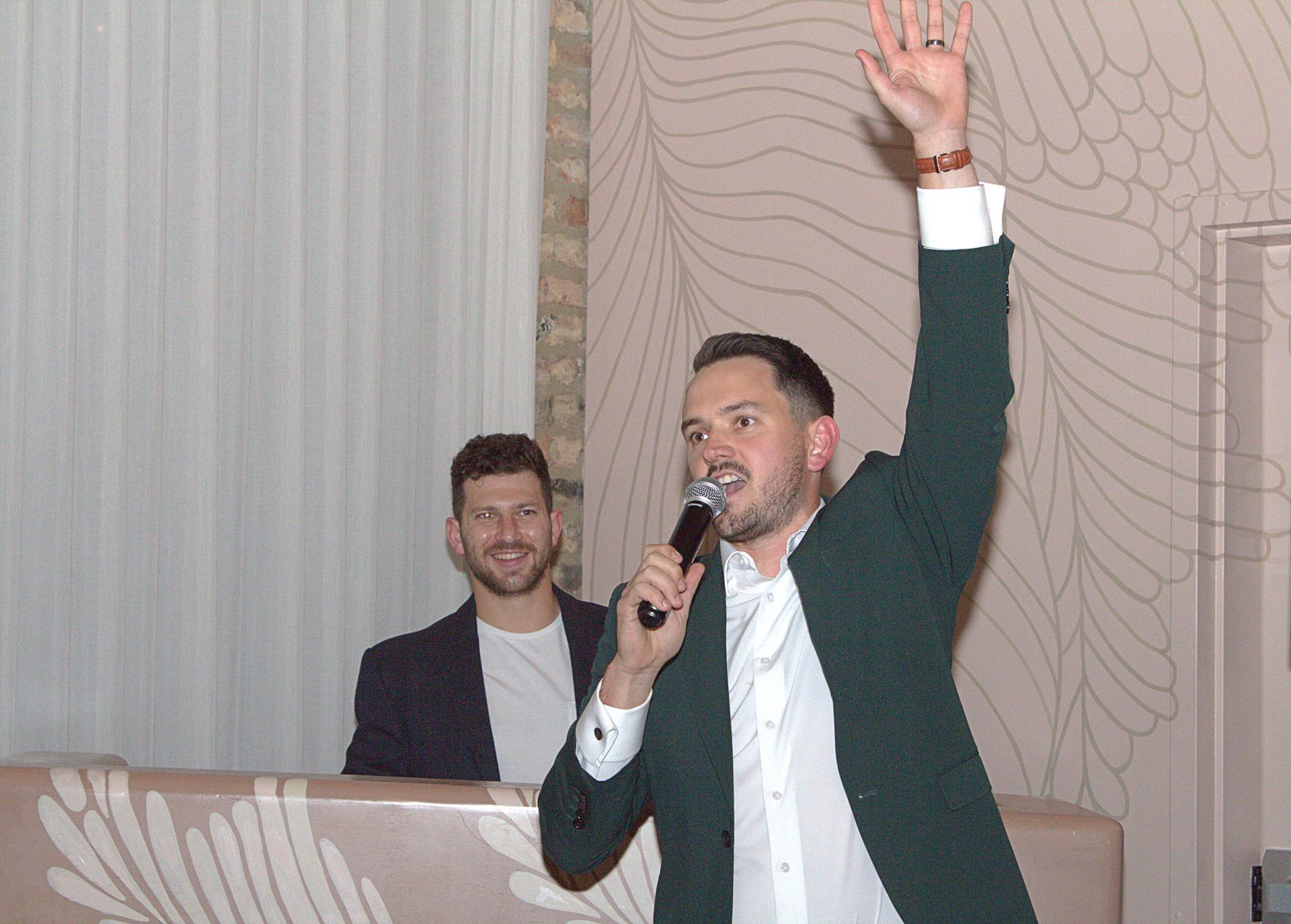 Event EmCee makes an announcement with the DJ in the background