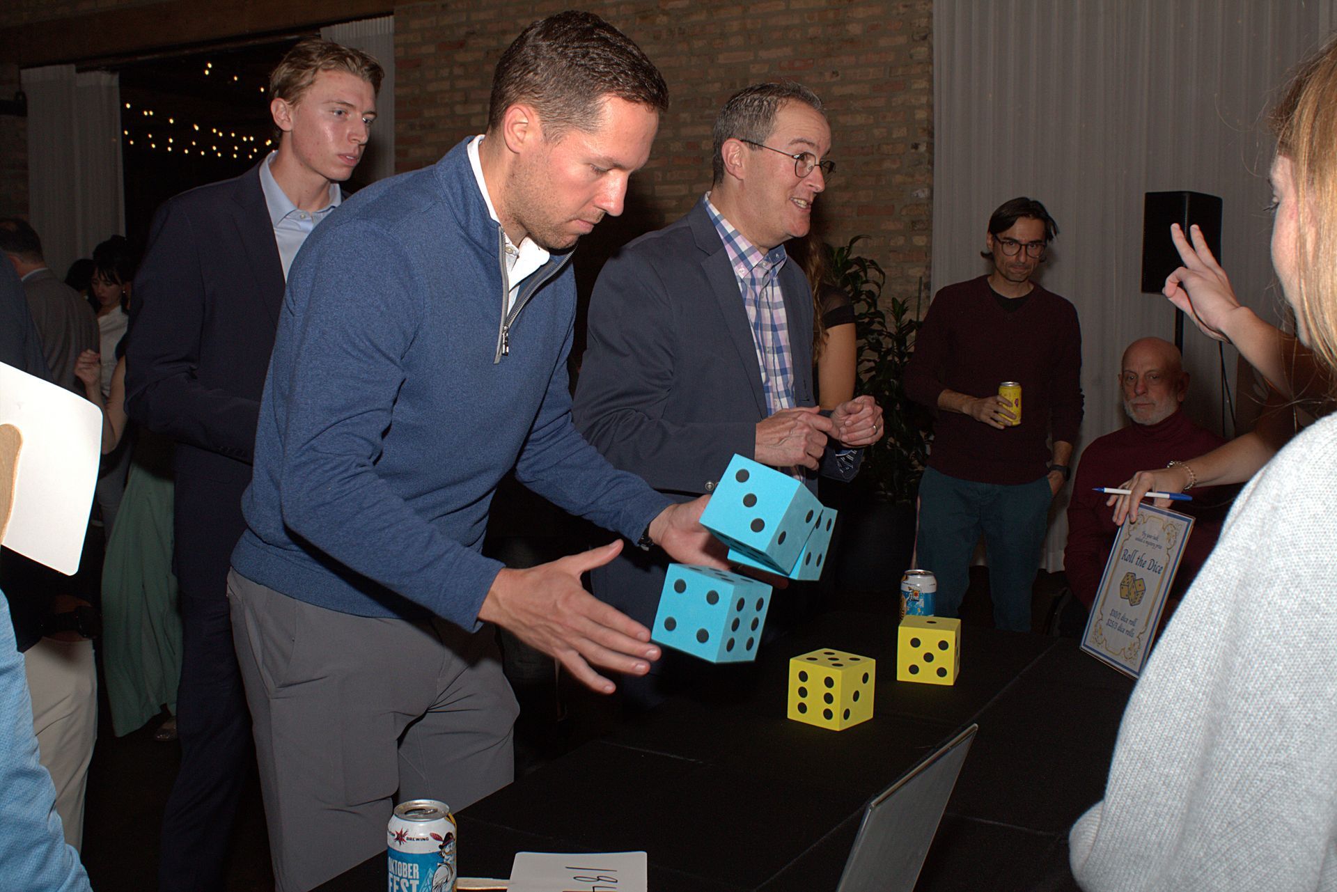 Two guests play one of the event games involving large dice