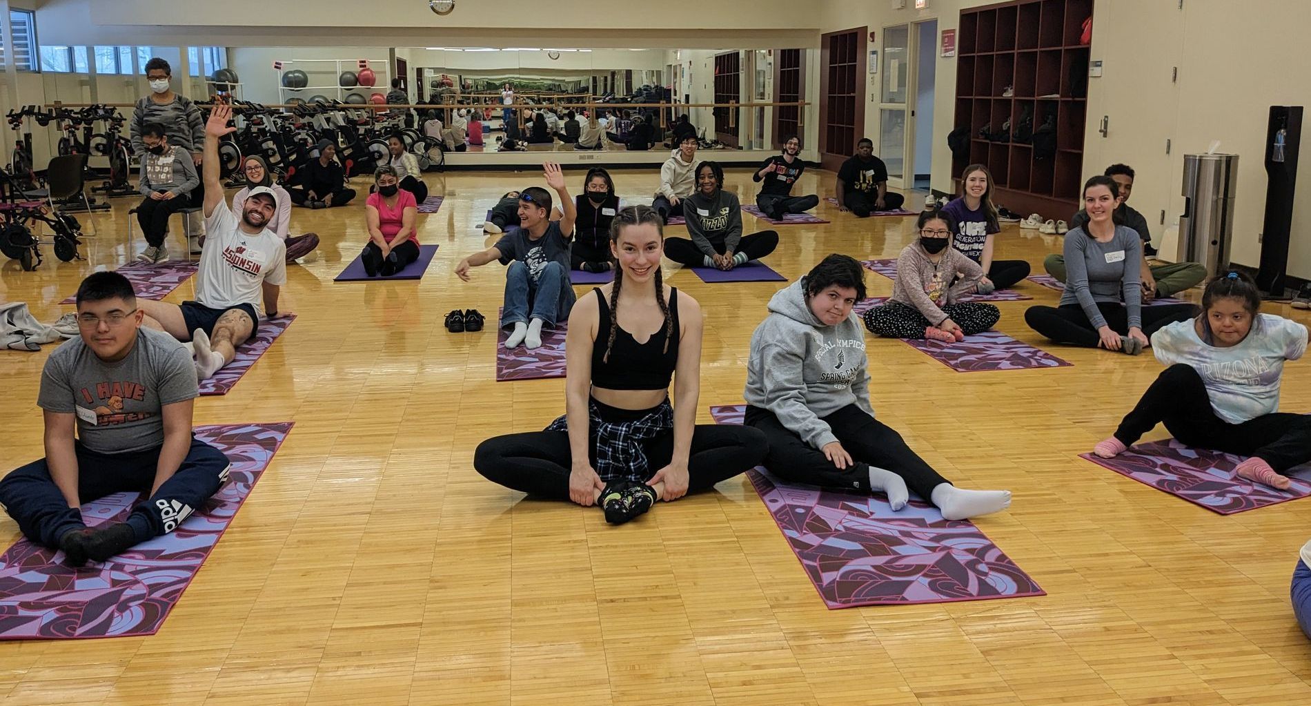 KEEN Athletes and volunteers sit in butterfly pose.