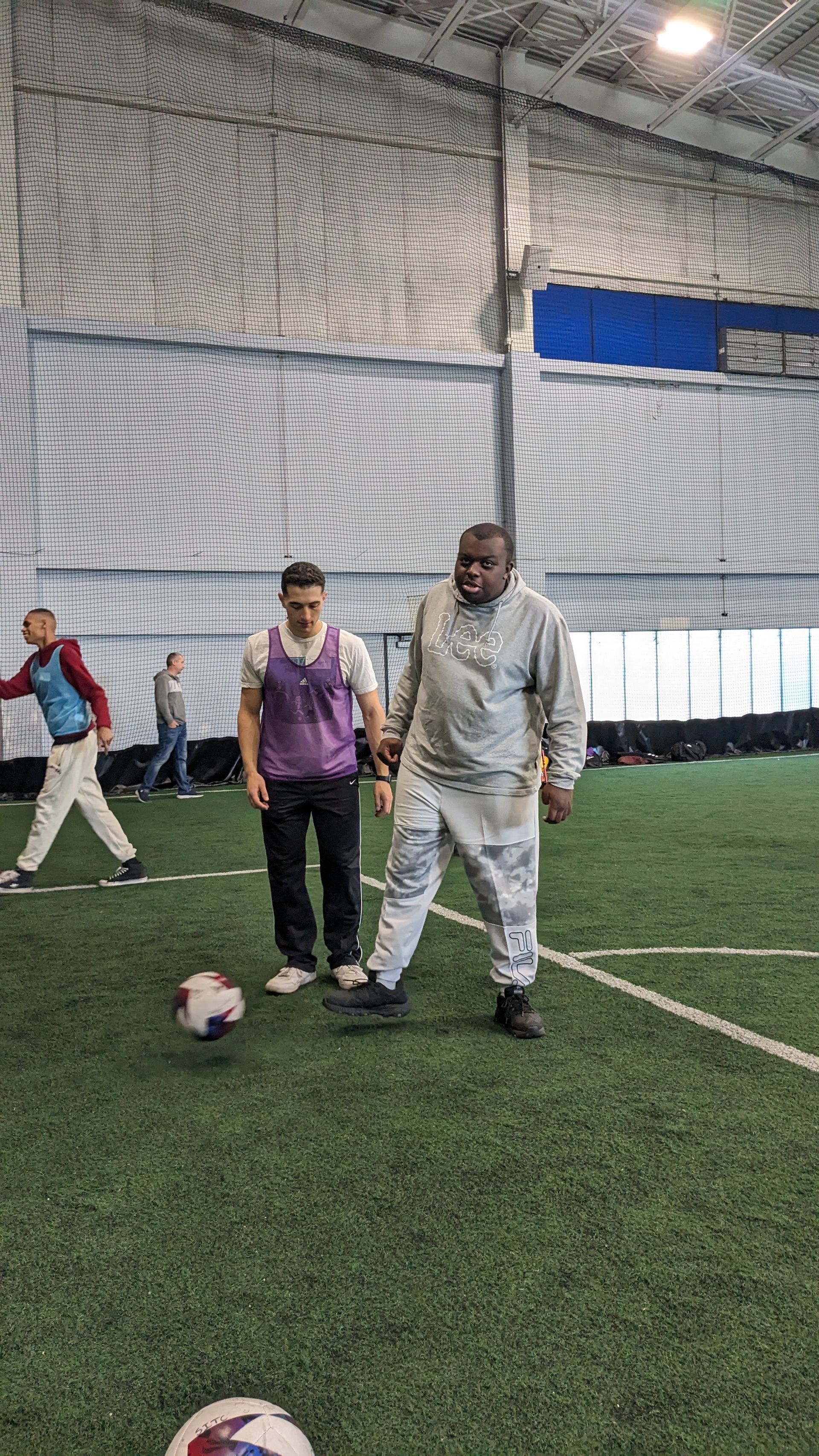 Young man and volunteer play soccer