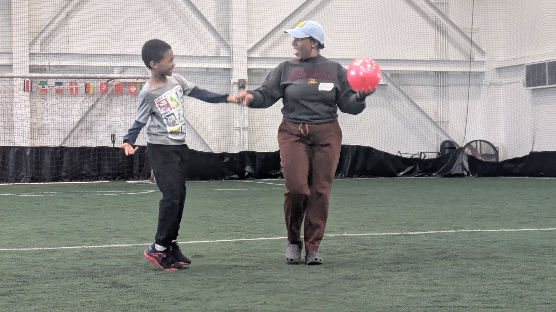 An Athlete and a volunteer engage with a ball