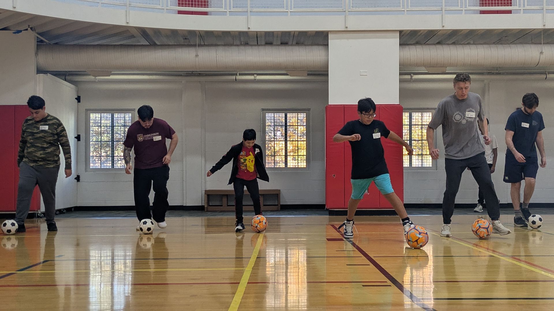 A group of Athletes kick a soccer ball