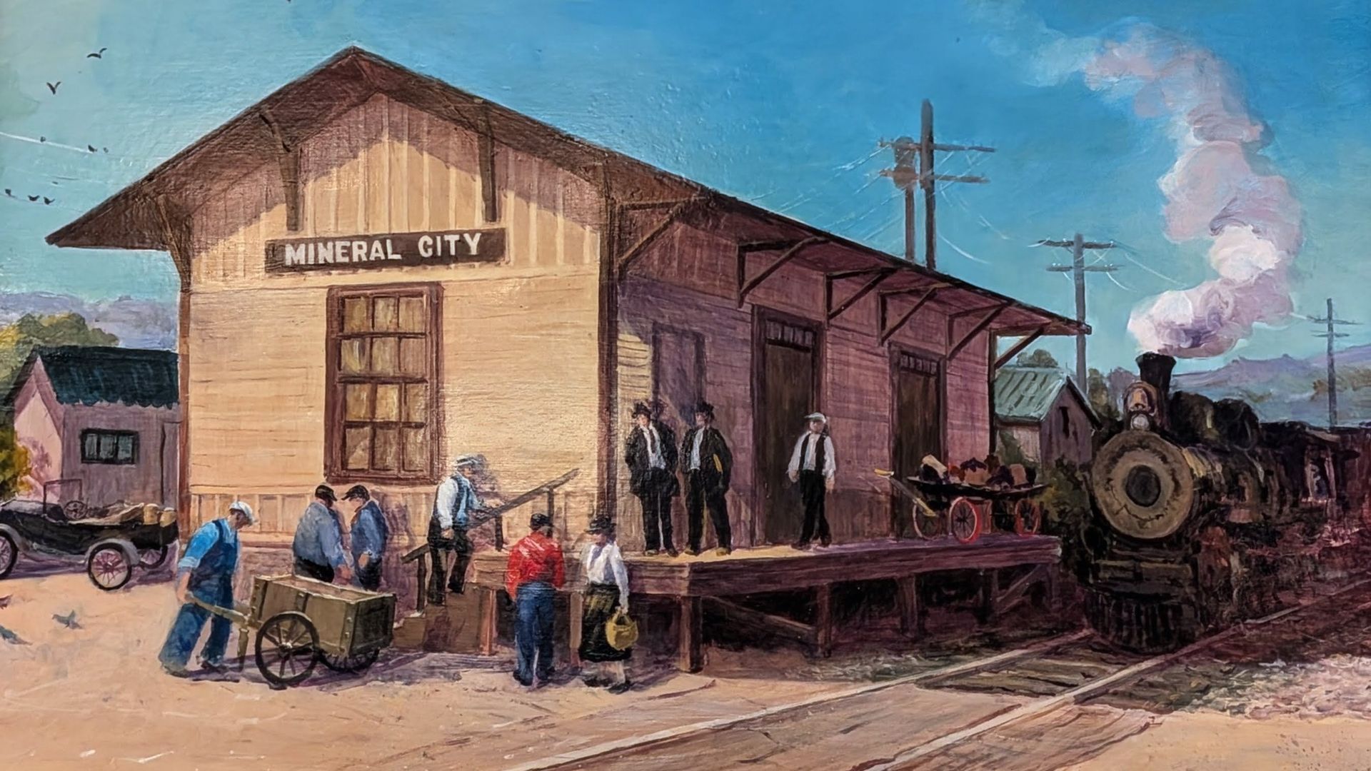 A lake view from a sandy shore, framed by autumn trees and a bench. Blue water, clear sky.