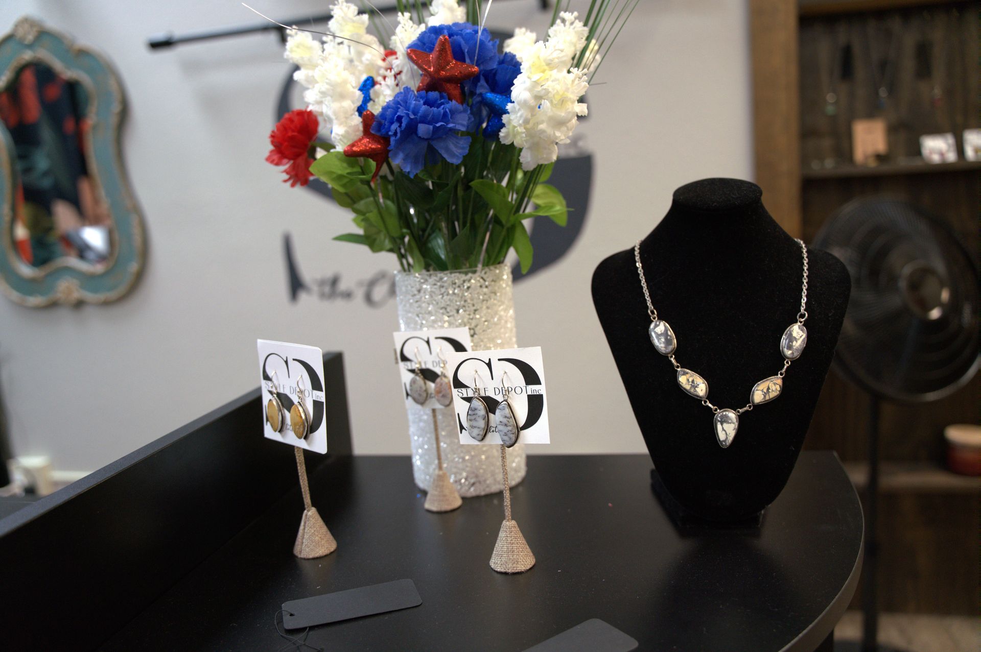 A jewelry display on a black counter.