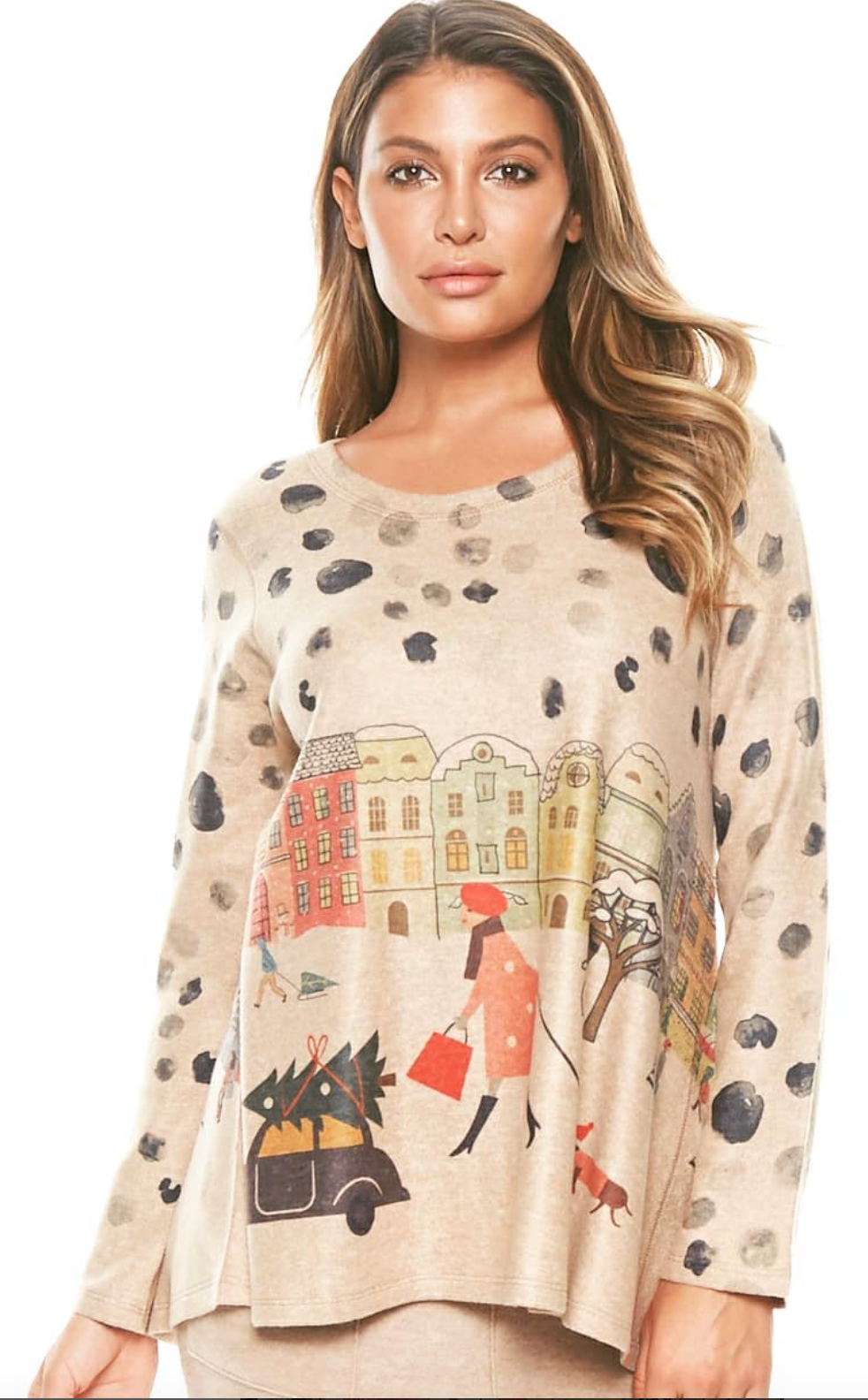 Woman wearing a beige sweater with a city scene illustration, polka dots, and a woman walking a dog.