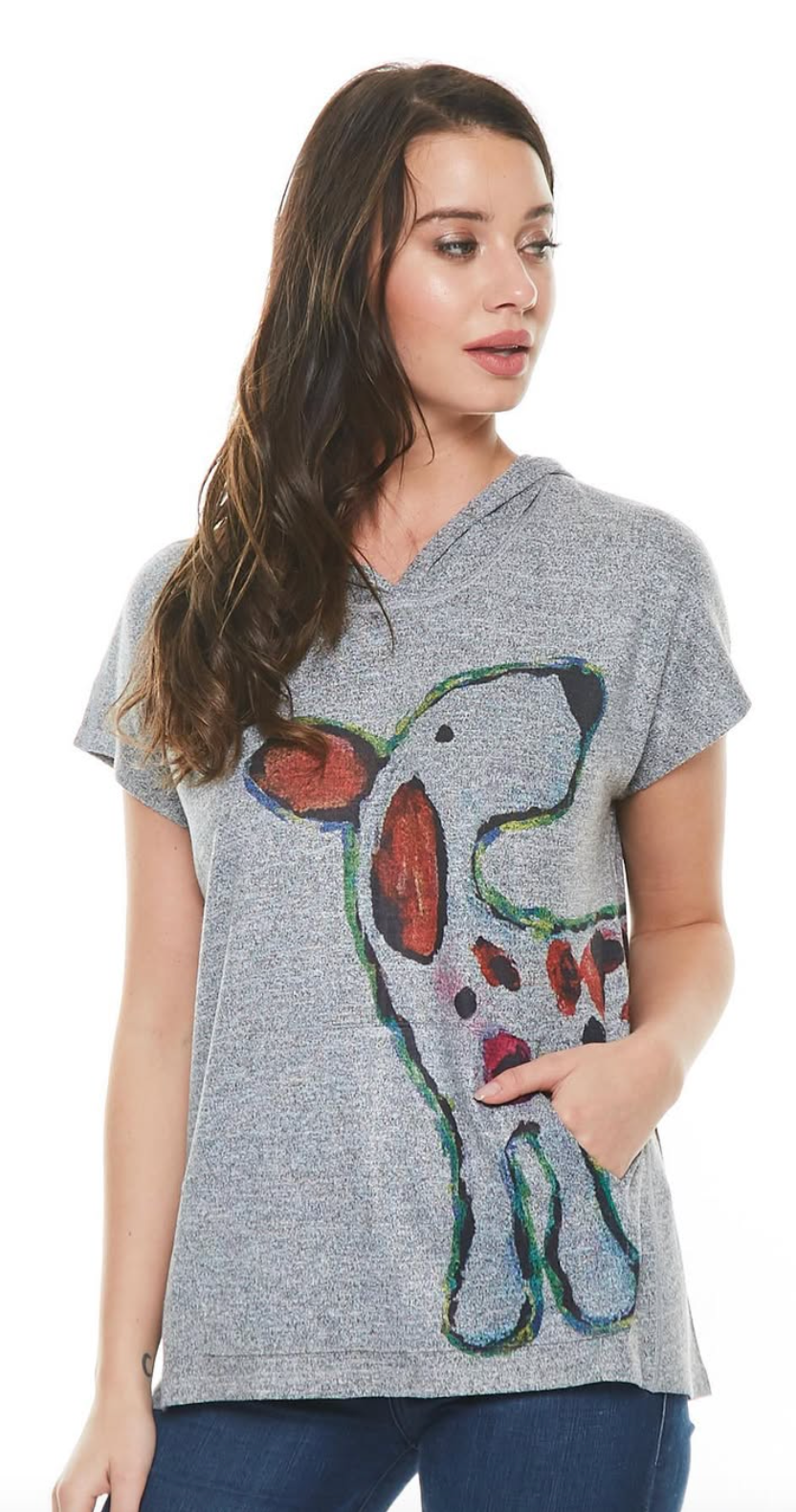 Woman in a gray hooded t-shirt with a dog drawing on it, looking slightly off-camera.