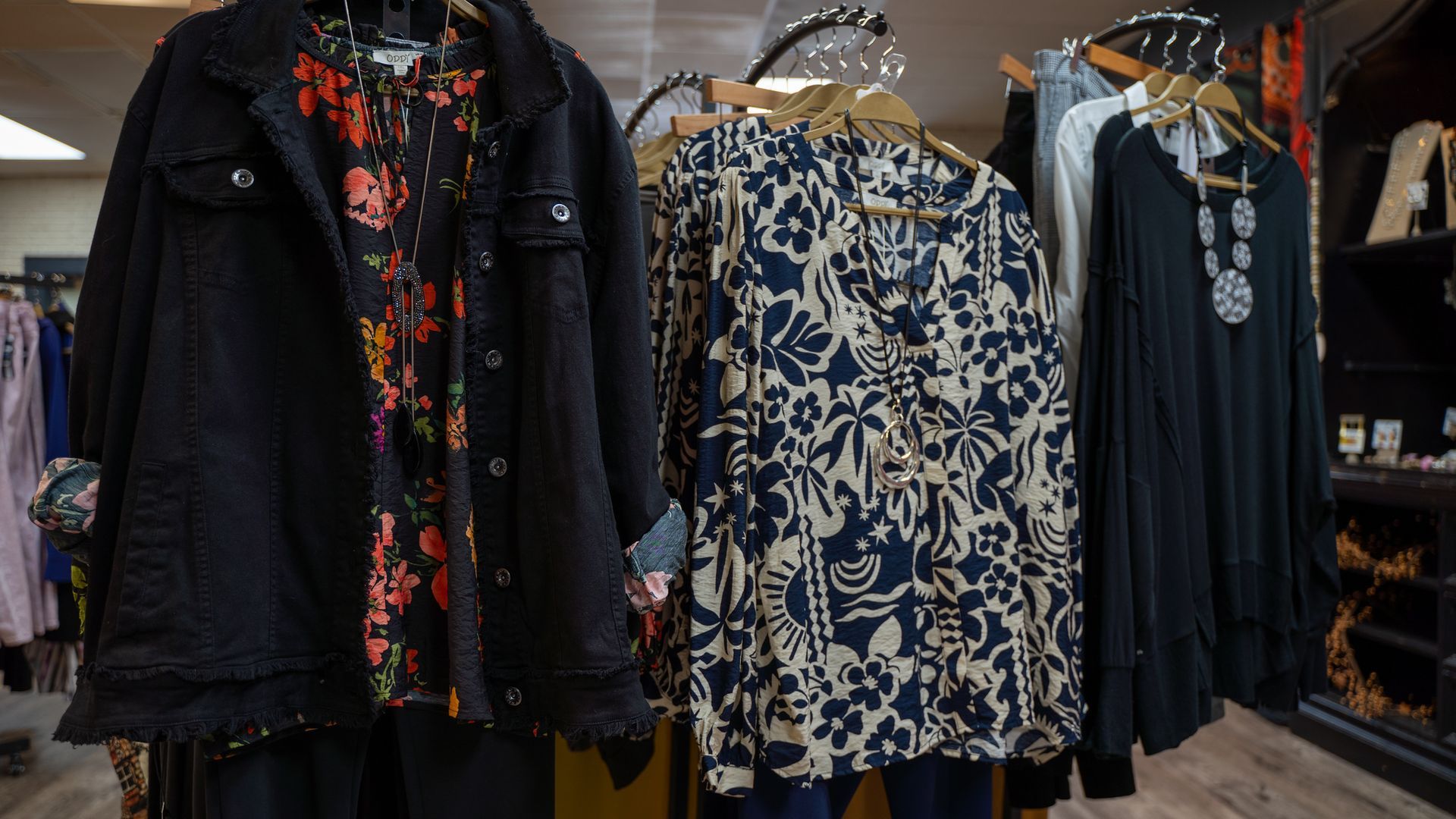 Clothing display in a boutique with accessories.