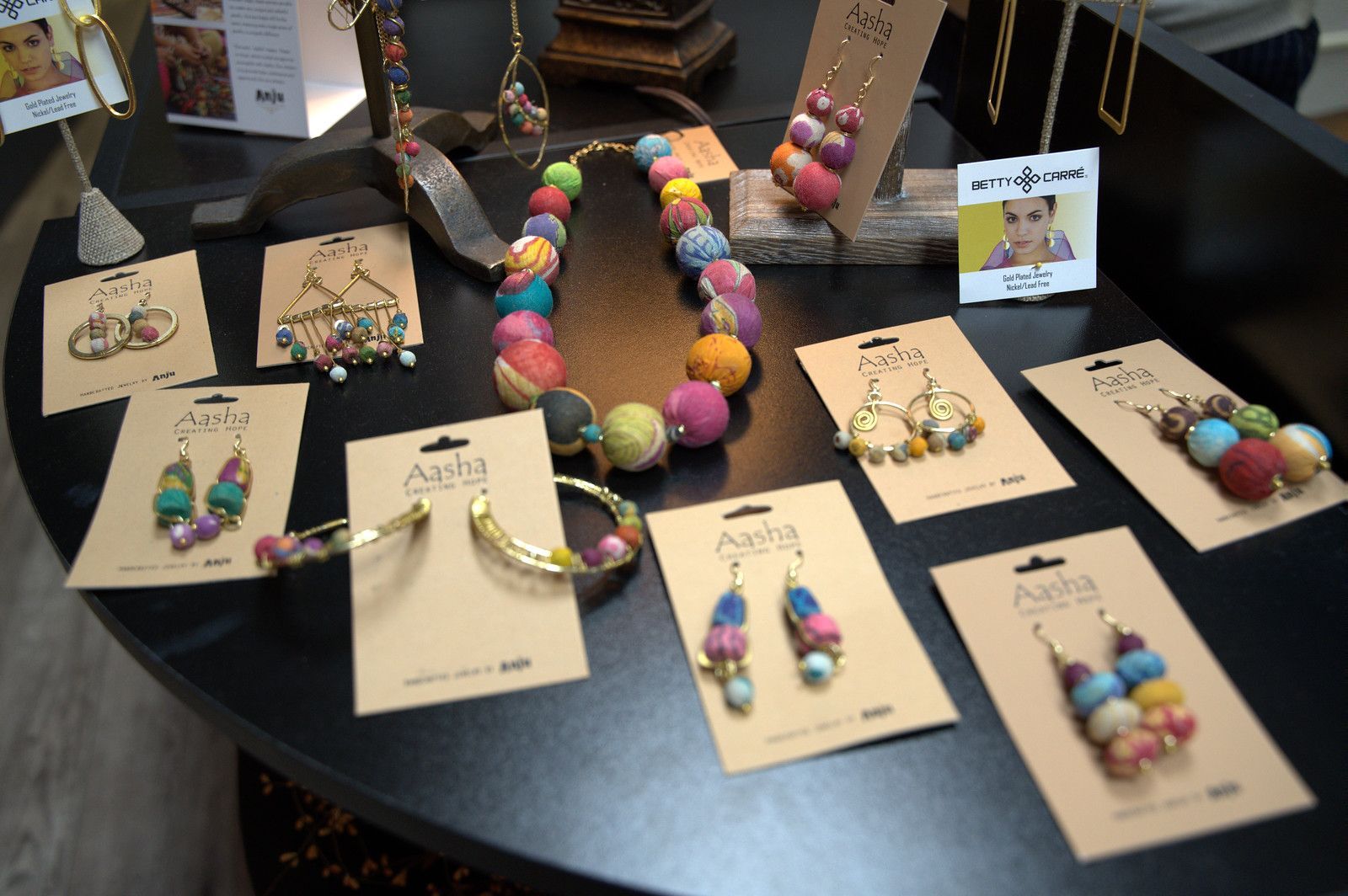 Jewelry display with colorful earrings, necklaces, and bracelets.