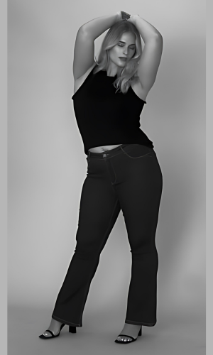 A woman in a black tank top and jeans poses, arms over her head, in a studio setting.
