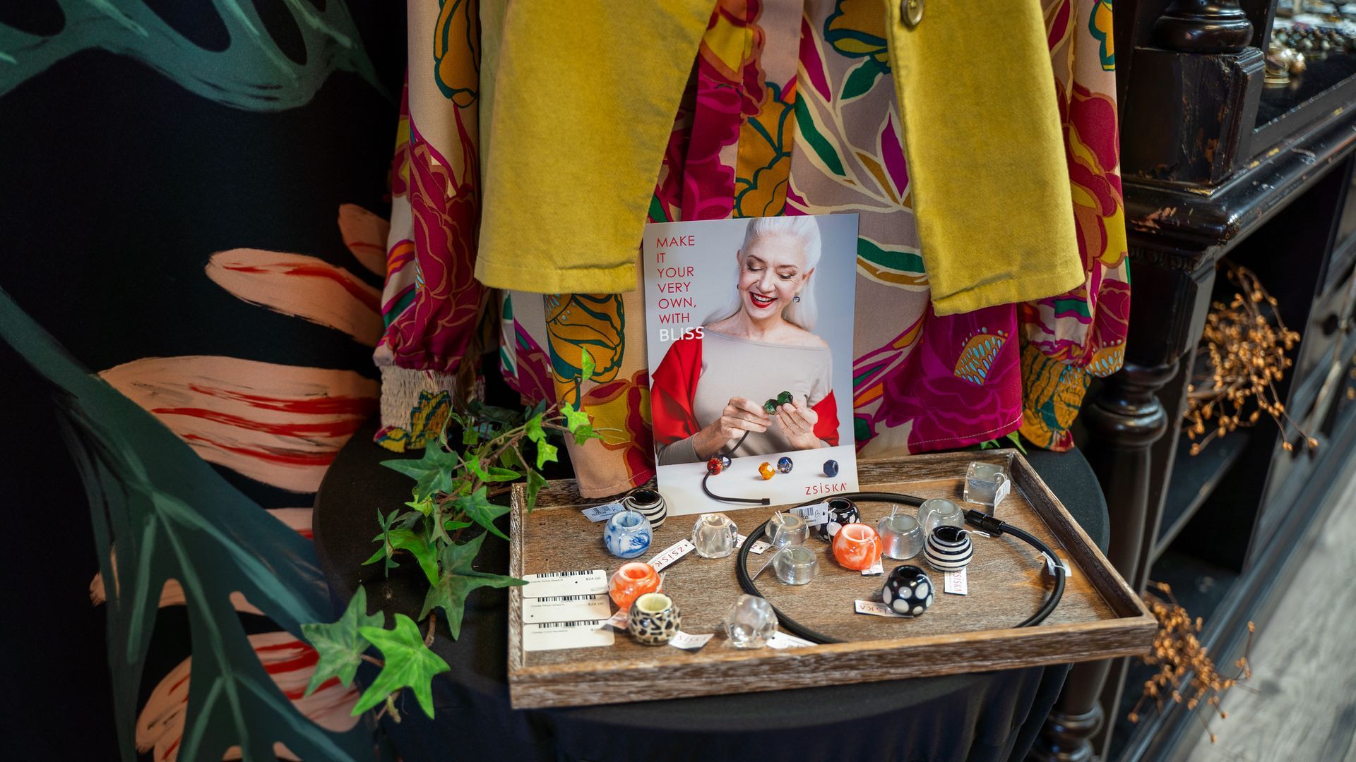 Display of bracelets and accessories, with a woman's portrait and clothing.