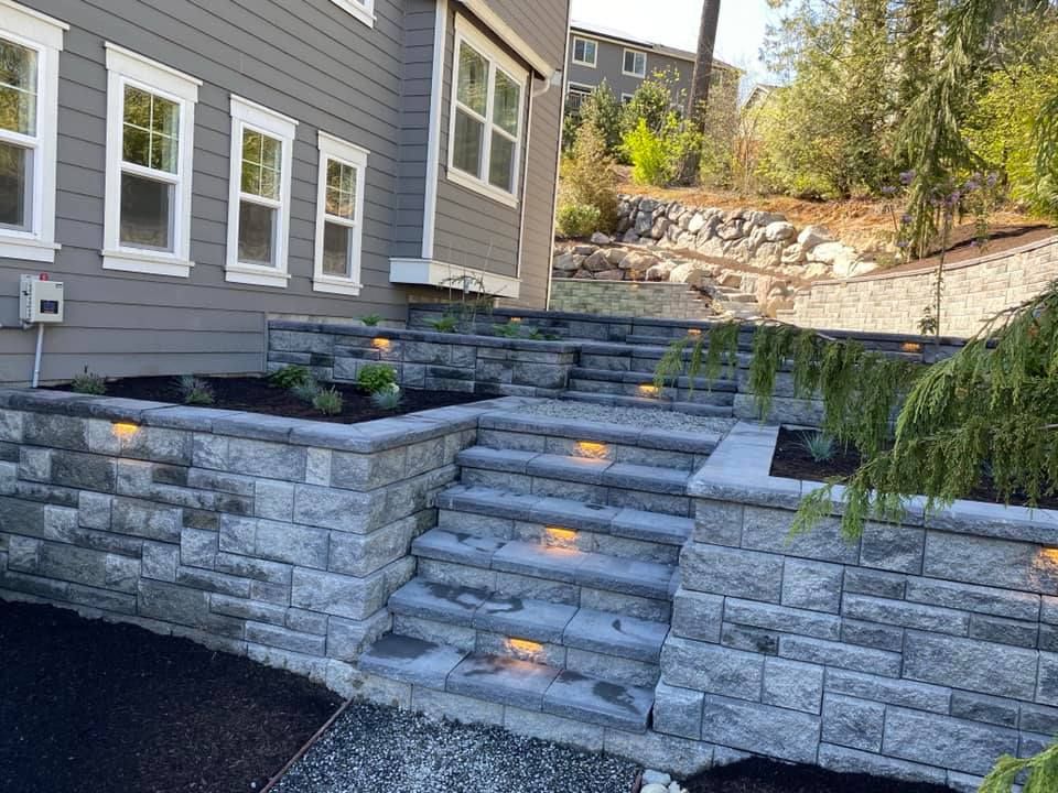 A brick wall with stairs leading up to a house.