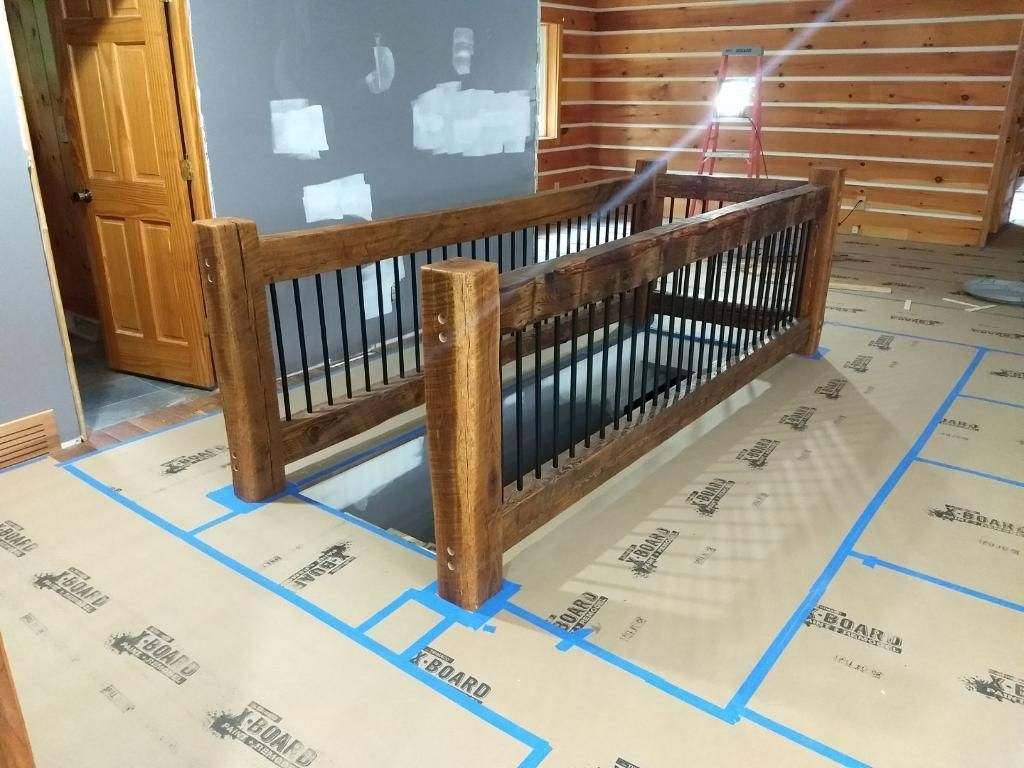 A wooden staircase is being built in a log cabin.