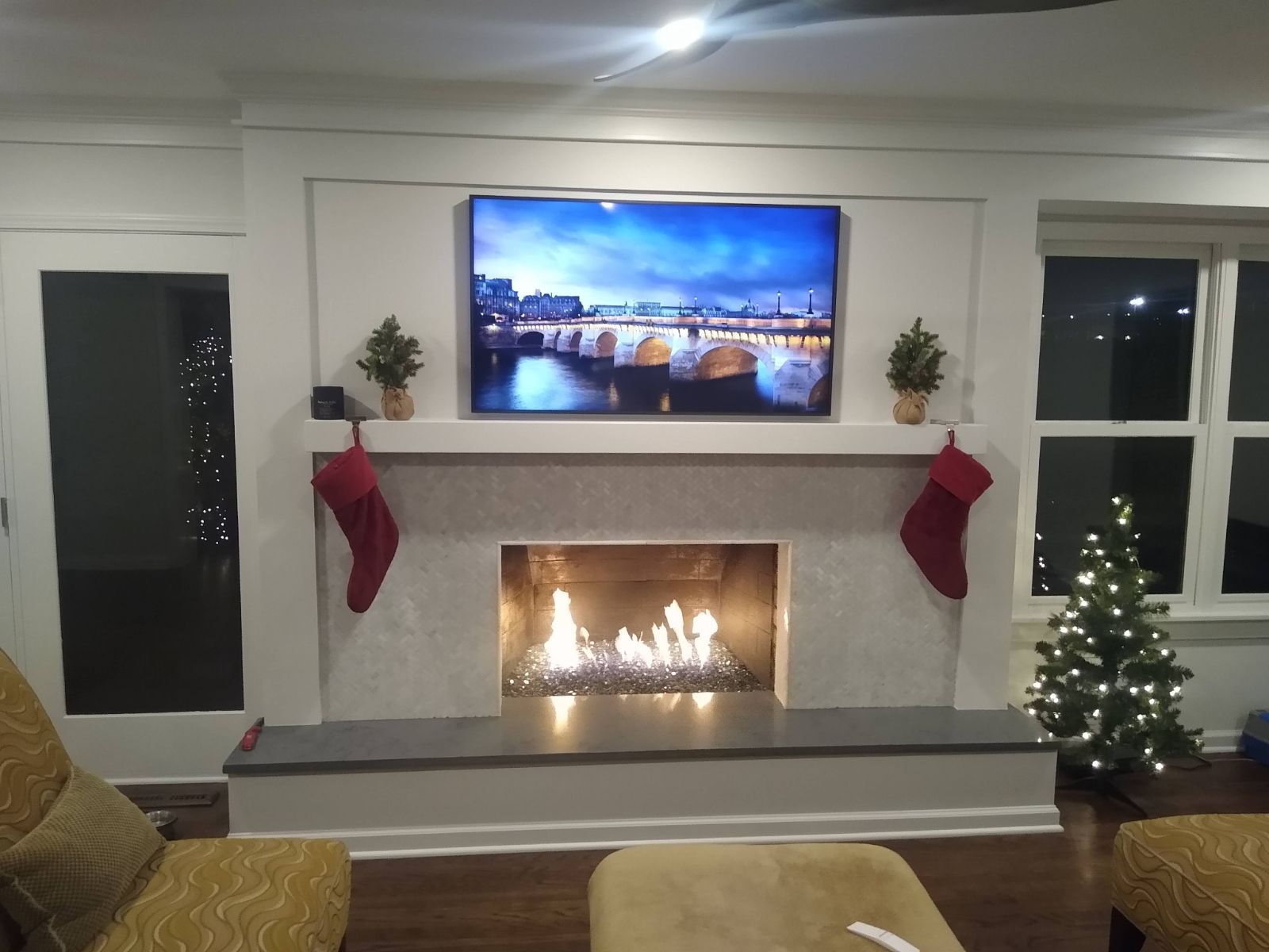 A living room with a fireplace and a flat screen tv