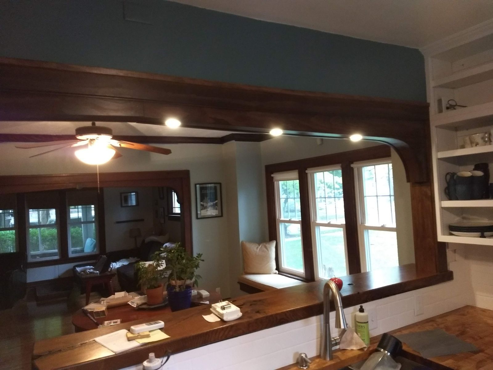 A kitchen with a sink and a ceiling fan