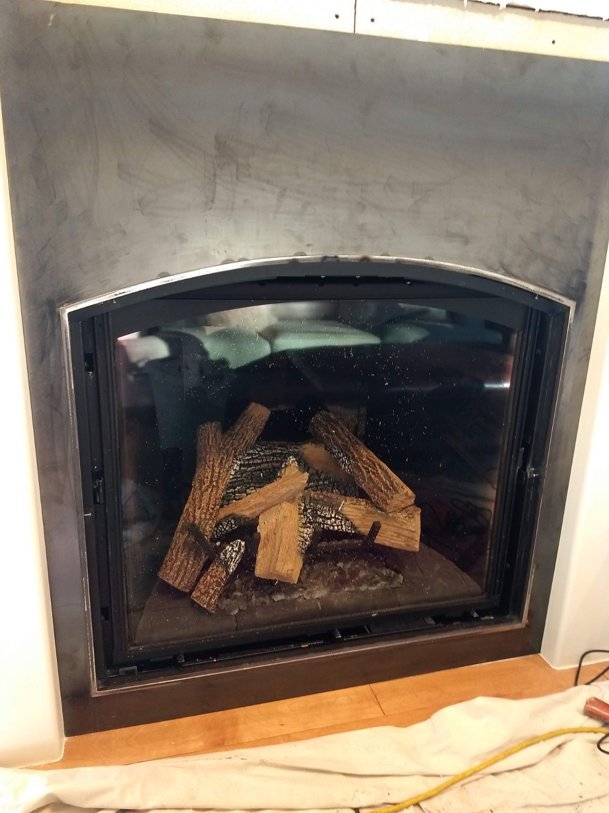 A fireplace with a lot of logs in it