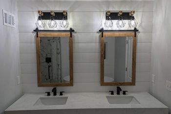 A white bathtub is sitting in a bathroom next to a window.