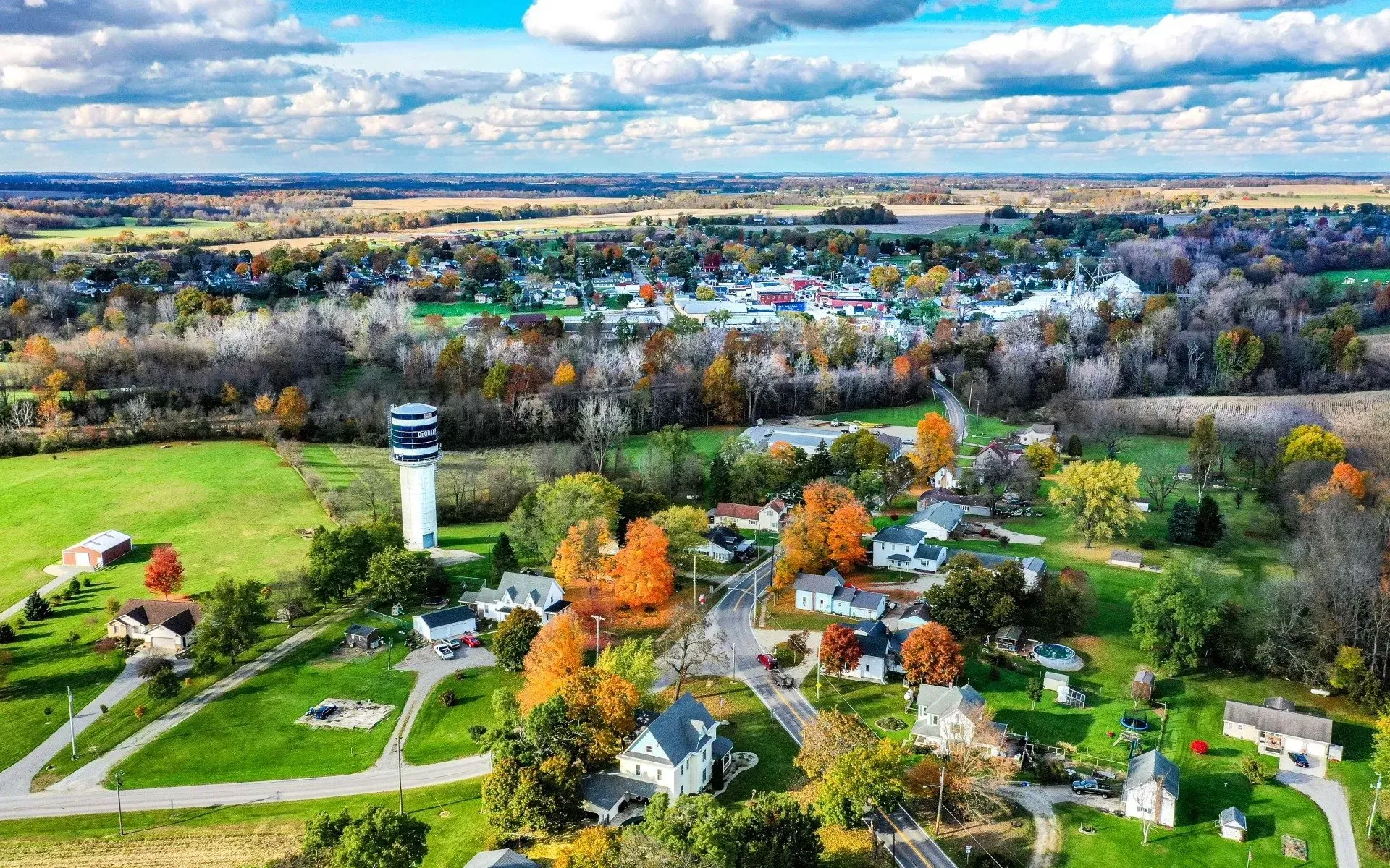 An aerial view of a small town with a water tower in the middle of it.