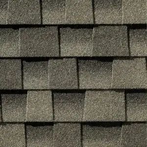 Close-up of overlapping gray asphalt roof shingles with a textured surface.