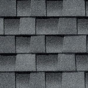 Dark gray asphalt roofing shingles arranged in a pattern.